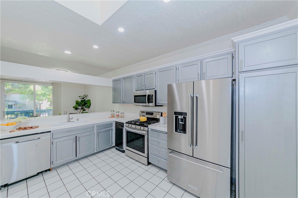 Welcome to this charming End-unit condominium in the gated Harbour Walk community! This bright and inviting home features a gourmet kitchen with tile countertops, stainless steel appliances, breakfast nook, and high ceiling. The cozy living room with fireplace. The dining area that opens to a private patio with laundry and extra storage. Upstairs, you'll find two primary suites, each with its own private bathroom and walk-in closet. Additional highlights include central A/C & heating, two assigned gated parking spaces (#414 & #459), and a convenient location near parking, mailbox, and pool. HOA dues of $714 include water and trash. The Harbour Walk community offers recent upgrades including a newer roof and exterior paint, plus resort-style amenities: pool, two spas, sauna, BBQ area, clubhouse, and ample guest parking. Prime North San Pedro location with easy access to the 110 freeway, scenic parks, waterfront, shopping, dining, and entertainment. Enjoy comfortable living in a move-in ready home!