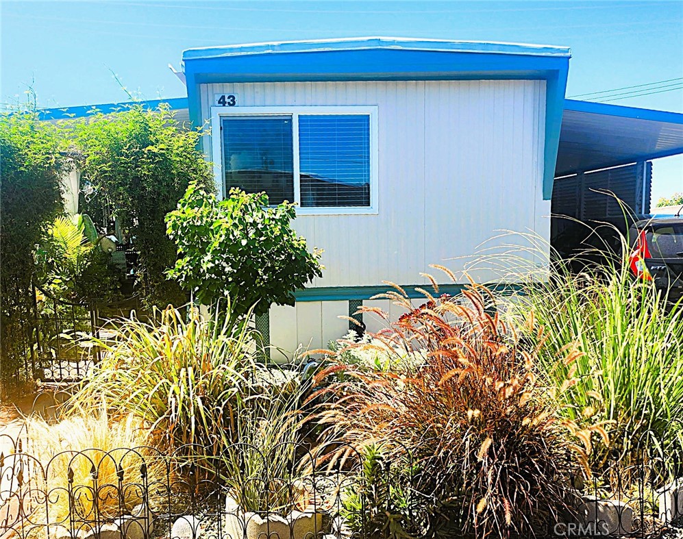 Welcome to your peaceful retreat in the heart of Yucaipa! This charming mobile home beautifully combines modern comforts with serene outdoor living, offering the perfect escape for those seeking relaxation and tranquility. Inside, you'll find freshly painted walls and brand-new waterproof vinyl flooring that perfectly complement the home's welcoming atmosphere. The kitchen is a cook's dream, featuring updated appliances, including a stove, sink, and a newer dishwasher for added convenience. Extend your living space with the fully enclosed 9'x15' BONUS ROOM Expando, thoughtfully renovated with a new ceiling to enhance your comfort. Natural light floods the space through French doors that open onto a newer deck, an ideal spot for morning coffee or hosting gatherings with loved ones. The bathroom offers a spa-like experience, with a reglazed bathtub, newer sink, and a toilet with a convenient bidet attachment. Outside, enjoy the private, beautifully landscaped yard, complete with a vinyl fence for added seclusion. Vibrant plants and white sands from Florida create a tranquil garden setting. For peace of mind, a security camera is included, and the property features a newer Power box with 220v, upgraded dual-pane windows, and a fresh skirt around the mobile home. Nature lovers will appreciate the abundance of fruit trees, including guava, avocado, persimmon, peach, apricot, pomegranate, and fig, all waiting to be enjoyed. This home isn't just a place to live; it's a sanctuary where modern convenience and natural beauty come together. Don't miss the chance to make this one-of-a-kind gem yours in the beautiful community of Yucaipa!