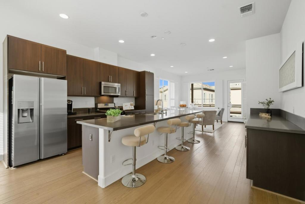 Welcome to modern living in the heart of Milpitas. This stunning corner-unit townhouse-style condo, built by award-winning Trumark Homes, blends contemporary comfort with everyday convenience. Built in 2014, the home features an open floor plan filled with natural light, highlighted by a spacious living area that flows to a private deck, perfect for relaxing or entertaining. The sleek kitchen boasts stainless steel appliances, ample counter space, and modern cabinetry. Upstairs, the primary suite offers a peaceful retreat with a large walk-in closet and expansive dual-pane windows, while a second bedroom and full bath provide versatility for guests or a home office. Additional features include in-unit laundry, high-end finishes, and an attached two-car garage. Ideally zoned for top-rated Mabel Mattos Elementary School, just a short walk away, and conveniently located near parks, golf courses, shopping such as the Great Mall, dining, and major tech employers. Enjoy easy access to BART and major freeways including 680, 880, 101, and 237, making commuting a breeze. Experience the best of Milpitas living in this beautifully maintained home.