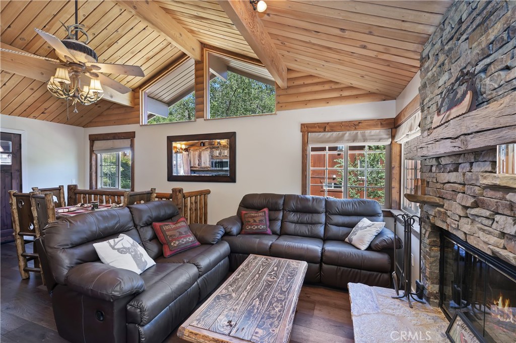 Shows like a brand new home! Master craftsmanship throughout this amazing cabin includes custom kitchen cabinets, custom lighting, custom doors, beautiful highly upgraded bathrooms and kitchen. You will enjoy several decks to marvel at nature and the seasonal creek that runs behind the house! The new side deck is HUGE and ready for you and your guests as well as a spa deck which overlooks the canyon with upper and lower decks for dining or viewing nature!. The home has a new roof, and new electrical throughout as well as luxury vinyl plank flooring, custom roman shades for the windows, a light and bright interior and comes fully furnished! The cement parking pad is so convenient, with just a few steps to the front door. This is the home for the buyer who values quality construction and fine finishes. The floorplan features a greatroom on the main level with 2 bedrooms and luxury bathroom, downstairs is a den/game room and master suite. Beautiful new windows let the sunshine into your fabulous pride of ownership mountain home! Close to Bear Mountain, lake and village of Big Bear Lake.