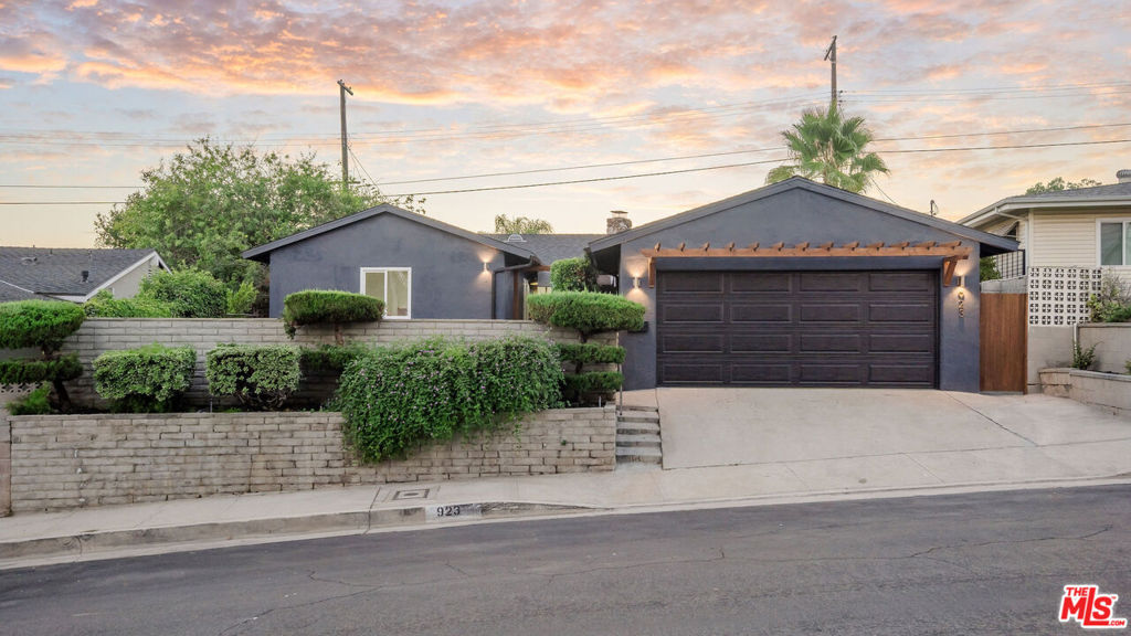 Tucked away in the serene enclave of Arroyo View Estates in Highland Park, this tastefully reimagined 3-bedroom, 3-bathroom home offers the perfect blend of privacy, sophistication, and effortless modern living. Located on a quiet street, the residence features an open, light-filled floor plan with warm mid-century modern details, tranquil hillside views, and a private backyard retreat surrounded by lush, curated landscaping. A gated front courtyard sets a welcoming tone, ideal for morning coffee or entertaining guests. Inside, natural light floods the airy interior, highlighting a statement fireplace, dedicated dining area, and a beautifully designed kitchen with quartz countertops, custom cabinetry, and seamless indoor-outdoor flow. Just beyond, a separate laundry room, stylish powder room, and direct access to the attached two-car garage add everyday comfort and convenience. The south wing of the home includes all three bedrooms, with the primary suite tucked privately at the rear corner, featuring dual closets and a sleek ensuite bath. Two additional bedrooms are separated by a spacious guest bathroom with a double vanity. Thoughtful upgrades enhance both style and function, including brand-new wide-plank flooring, brand new windows throughout, new foldable glass doors for seamless indoor/outdoor living off the living room, a new roof, designer finishes, refreshed landscaping, new skylights, and sewer line improvements, making this home truly move-in ready. Ideally located near the South Pasadena border, just minutes from the energy of York and Figueroa, the charm of Old Town Pasadena, and the eclectic vibes of Eagle Rock, with quick access to the 110 Freeway and Downtown LA; this home delivers a rare combination of hillside tranquility and urban connectivity, where modern luxury meets elevated everyday living.