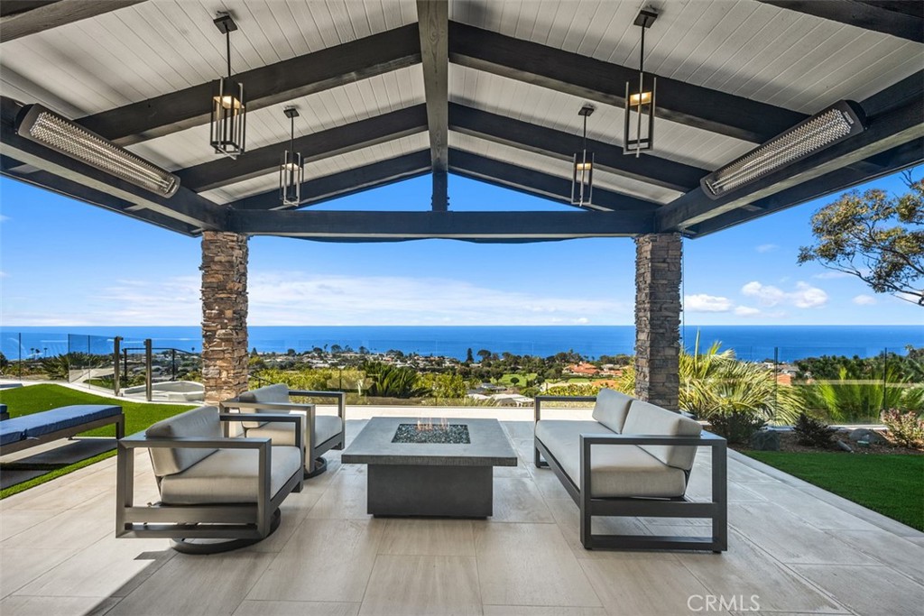 Welcome to 32311 Caribbean Drive, an exceptional single-level residence in the prestigious Monarch Bay Terrace offering breathtaking panoramic views of the ocean, coastline, and whitewater. Expertly designed and renovated with top-of-the-line materials, fixtures, and finishes, this elegant and private home features a seamless open layout designed for luxurious coastal living. Enter through a beautifully landscaped courtyard with a tranquil fountain into a grand foyer that opens to a light-filled oversized great room with floor-to-ceiling glass showcasing stunning ocean, Catalina Island and exquisite sunset in views. The spacious living area includes an elegant fireplace, entertainment center, and custom built wine cellar as well as a casual dining area, all flowing effortlessly to an expansive beautiful ocean view covered patio with built-in heaters and a fire pit for perfect indoor-outdoor living all year round. The formal ocean view dining room and the beautifully designed chef’s kitchen are appointed with high-end lighting fixtures, chef's kitchen features natural stone counters, top of the line appliances and bespoke cabinetry. The private ocean-view primary suite offers a double-sided fireplace, dual French doors, a heavenly spa-like bath suite, two amazing walk-in closets, and a great laundry room. The private office and two additional guest suites with own hallway access and laundry, ensures privacy and comfort for all. The beautifully landscaped backyard features a built-in BBQ, a second fountain, and a fire pit, all set against the backdrop of stunning sunsets over Catalina Island —this is coastal luxury at its finest. The highly sought after Monarch Bay Terrace is located on a luxurious corridor between Laguna Beach with famous galleries & The Montage Resort and the beautiful Monarch Beach with pristine beaches, the Ritz Carlton, Waldorf Astoria, Monarch Golf Links, and not to be missed: the beautiful Dana Point Harbor which is undergoing major & fabulous upgrades with two new boutique hotels and lots of new shops and restaurants plus water sports and boating activities.
