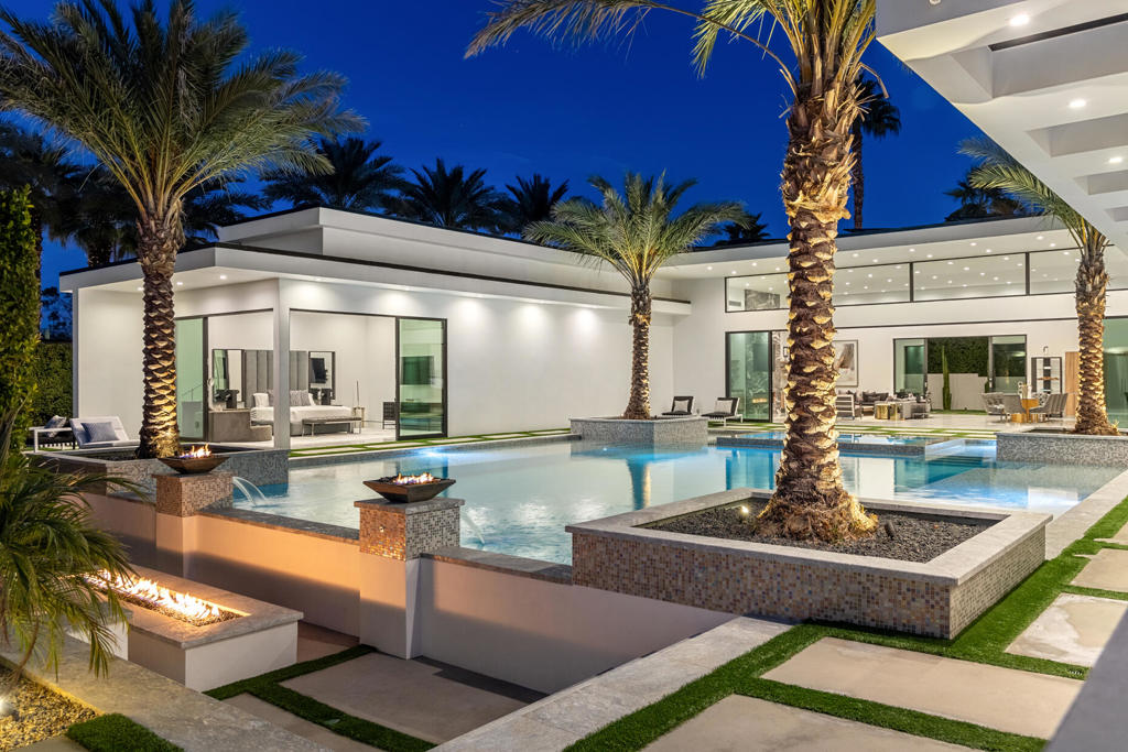 Welcome to Bravo 7, located in the heart of Tamarisk, in Rancho Mirage. This private enclave of seven curated luxury homes by architect James M. McEachern and Developer Bravo Development is now hitting the market for the first time. This luxury estate at Bravo 2 boasts an oversized pool with two tiled Baja shelves and a step-down bar area with a fire pit. Upon entering through the pivoting glass door, you will be greeted by an impressive interior featuring soaring ceilings, fold-away glass doors, imported polished marble from Spain, and sleek custom cabinetry imported from Germany. The bathrooms and kitchen are adorned with high-quality Hansgrohe fixtures. The spacious great room, complete with a linear fireplace, is perfect for hosting grand-scale gatherings and seamlessly connects to the kitchen, backyard, and pool area. The estate offers 5 ensuite bedrooms and 5.5 baths, equipped with Fleetwood doors and windows, Miele appliances, smart-home lighting and communication systems, and luxurious Italian cabinetry in the primary suite's walk-in closets. Other notable features include illuminated bath mirrors, solar power, and a 3-car garage with epoxy flooring. This prestigious residential collection is conveniently located near The Ritz-Carlton Resort & Spa, Sunnylands, Palm Springs International Airport, luxury shopping, and fine dining. It presents an unparalleled opportunity to live a grand lifestyle that many can only dream of