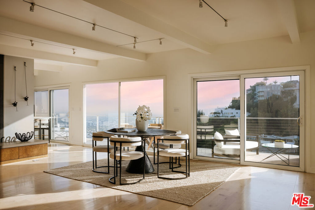 Just above the iconic Sunset Strip, this sleek contemporary home captures sweeping 180-degree views from the hills to the ocean. Floor-to-ceiling glass doors open to two expansive, newly renovated double-decker decks, perfect for seamless indoor-outdoor living and sunset entertaining. The light-filled interior features an open layout with wood-beam ceilings, a modern fireplace, and a designer kitchen that flows into the living and dining areas. All three bedrooms are on the lower level, including a spacious primary suite with its own fireplace, walk-in closet, and direct access to the lower deck, all with stunning views. Located in the heart of the Hollywood Hills, just moments from top restaurants, boutiques, and nightlife, this is a rare opportunity to own a true view property in one of L.A.'s most coveted neighborhoods.