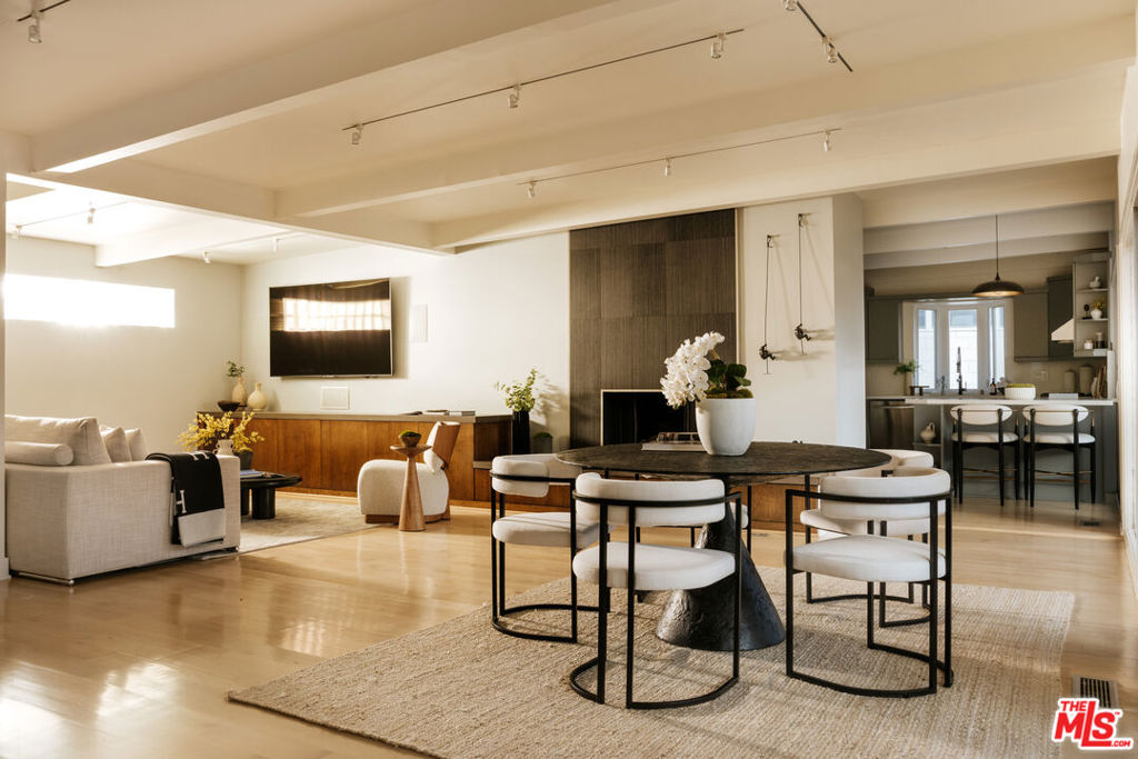 Just above the iconic Sunset Strip, this sleek contemporary home captures sweeping 180-degree views from the hills to the ocean. Floor-to-ceiling glass doors open to two expansive, newly renovated double-decker decks, perfect for seamless indoor-outdoor living and sunset entertaining. The light-filled interior features an open layout with wood-beam ceilings, a modern fireplace, and a designer kitchen that flows into the living and dining areas. All three bedrooms are on the lower level, including a spacious primary suite with its own fireplace, walk-in closet, and direct access to the lower deck, all with stunning views. Located in the heart of the Hollywood Hills, just moments from top restaurants, boutiques, and nightlife, this is a rare opportunity to own a true view property in one of L.A.'s most coveted neighborhoods.