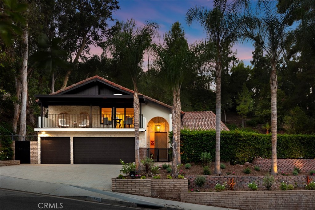 Discover a newly reimagined Spanish-style home by B/Spoke Design, nestled in a sought-after Woodland Hills neighborhood south of Ventura Boulevard. This stunning 4-bedroom, 3-bathroom residence spans just under 2,500 square feet, offering an exquisite blend of classic Spanish charm and modern luxury.
Step inside to find rich chocolate-colored wide plank oak flooring seamlessly transitioning into beautifully restored original Saltillo stone pavers. The living room is bathed in natural light, featuring a grand PRL multi-slide door that effortlessly connects the interior to the lush backyard oasis. Gaze up at the refinished open beam cathedral ceilings, mirroring the beauty of the floors and cabinetry, adding to the home's grandeur.
The spacious dining area flows seamlessly into a chef's dream kitchen, boasting custom cabinetry, dazzling countertops, and a complete suite of high-end Thermador appliances. A separate family room offers a cozy retreat with a wood-burning fireplace, a convenient wet bar, and under-stair wine cellar.
A downstairs bedroom and a fully remodeled bathroom provide convenience and flexibility. Upstairs, three additional bedrooms await, including the luxurious primary suite. A remodeled hallway bathroom serves the two guest bedrooms, while the primary suite offers a haven of relaxation.
The primary suite features a striking wood-planked accent wall, a spacious walk-in closet, a private covered balcony, and an en-suite bathroom with a separate tub and shower, all adorned with high-end custom finishes.
The backyard is a private sanctuary featuring a newly renovated pool and spa, complete with new plumbing, equipment, coping, tile, and plaster. All hardscaping has been meticulously replaced with new concrete pavers. Beyond the inviting pool deck, discover a sizable paver patio off the family room, perfect for entertaining, and a custom-built firepit for enjoying evenings under the stars.
This home boasts numerous notable upgrades, including newer systems, such as a brand-new roof, updated HVAC, new 200 amp electric panel, energy-efficient Milgard Trinsic windows, designer light fixtures, a comprehensive camera security system, and integrated speakers throughout the house and backyard. It's also fully wired for data and TVs, ensuring seamless connectivity. A large three-car garage provides direct access to the home, adding an extra layer of convenience.