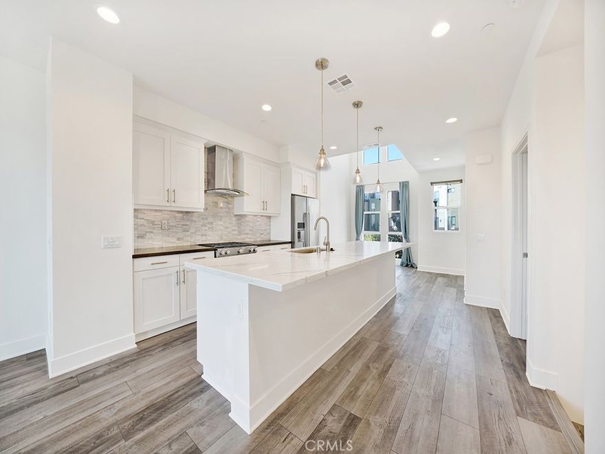 Welcome to 1658 Topanga, a sleek and spacious residence nestled in the heart of Costa Mesa’s coveted 17 West community. As one of the largest loft-style floor plans available, this contemporary home effortlessly blends style, functionality, and comfort across four expertly designed levels.



The first floor offers a private bedroom with an en suite bath, ideal for guests or a home office. The second level opens to an expansive great room where soaring 18-foot ceilings in the dining area and open-concept living space create a dramatic statement allowing for plenty of natural light. Upstairs, the primary suite and additional guest bedroom each feature their own en suite bathrooms, while the top-floor flex space provides yet another retreat, perfect as a media room, studio, or additional guest quarters.



Designed with entertaining in mind, this home offers three distinct outdoor areas, ideal for savoring the coastal breeze or hosting guests. Every detail has been thoughtfully curated, from energy-efficient upgrades including spray foam insulation, dual low-E windows, a tankless water heater, and high-efficiency HVAC, to finishes like quartz countertops, luxury vinyl flooring, designer mosaic tile, and built-ins.



Community amenities offer social and recreational experiences with a community BBQ, bocce ball court, dog run, playground, and fire pits. Just moments from the beach and within close reach of the area’s best dining, shopping, and parks, 1658 Topanga delivers modern coastal living.