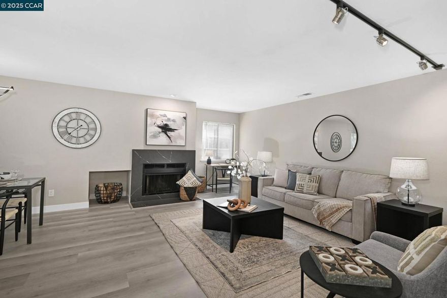 OPEN SUNDAY 1-4! Beautiful Ground Floor, Corner Unit in a tranquil, wooded location. Remodeled throughout. Sharp, open kitchen with quartz countertops, white shaker cabinets and stainless-steel appliances including a gas range. Two remodeled bathrooms with quartz countertops. Large primary bedroom suite plus a second bedroom with full bath. Full sized laundry closet inside the unit. Spacious living room with cozy wood burning fireplace. Modern touches throughout, including LVP flooring, lighting and fixtures. Freshly painted. Pleasant views of green-belt and park.  Large one-car garage with ample storage, plus assigned parking space. Wonderful, private backyard deck overlooking the trees and green belt. Convenient location with proximity to shopping, restaurants and easy commutes with Hwy 4 and I-680 nearby. Just across the street from Holiday Highlands Park.