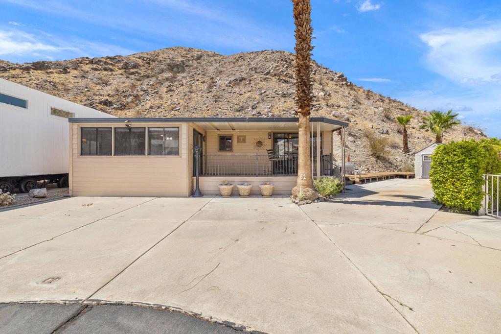 Welcome to this unique Mobile home in the desirable Sun Gate Community. There are two lots next to a beautiful mountain with the potential option to adding another unit or have more parking. Residents enjoy access to two pool, jacuzzis, a well maintained clubhouse and convenient laundry facilities. Close to local shopping, movie theaters, scenic walking trails, and more. This home combines comfort, convenience, and community living in one.