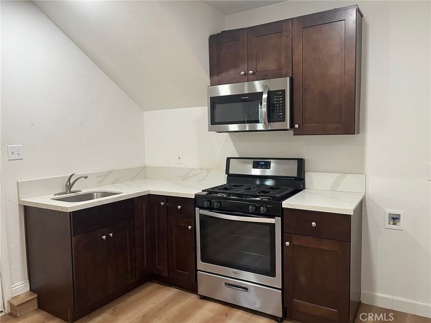 Cozy lower end unit of a triplex located in the mountains. 1 bedroom, 1 full bathroom with wood laminate floring throughout and ceiling fans in the bedroom and the living room areas. Newer appliances in the kitchen, including microwave, stainless steel sink and gas range. Living room has wall A/C-Heater unit. Separate bedroom with closet. Step up to a full bathroom including a shower over the tub, toilet, sink and hook-ups for a full-sized washer and gas dryer inside the bathroom. Private entrance from the rear and ample uncovered parking on the side for multiple vehicles or an RV. Property is located off of an unmaintained dirt road. There are other houses on the property and the back yard area is shared with other tenants. It's not fenced off separately. Pet Friendly, but please call on pets. Cats or dogs are welcome. (No separate yard). Prefer non-smokers. There is No garage. There is an additional monthly flat fee of $200 per month for all utilities; shared well water, trash, electricity and gas. Great for budgeting! Conveniently located close to schools, stores, restaurants, and just minutes away from the Ortega Highway or the I-15 Freeway. Freshly cleaned and available now.