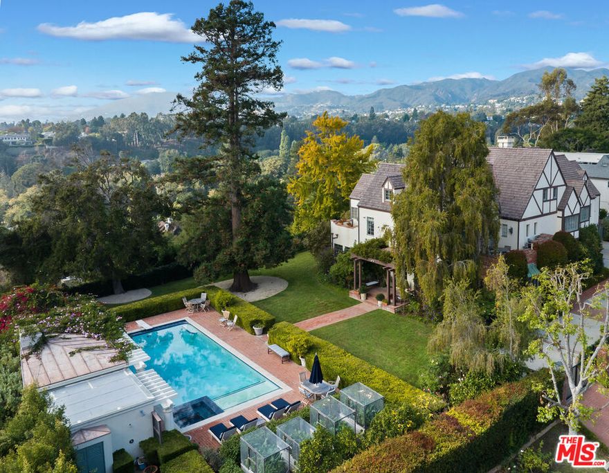 This Gated, private Estate on the South Amalfi Rim has spectacular mountain and ocean vistas. Set in the heart of the Riviera Palisades on approximately 24,830 sq/ft of meticulously landscaped gardens and spacious grounds. Featuring 8 Bedrooms, 10 Bathrooms and captivating, timeless detail throughout, this property is the opportunity of a lifetime. The grand yet charming foyer offers a warm welcome as you enter, showcasing a pronounced staircase followed by an intimate den with fireplace. Down the hall, you will find a generously sized living and family room with high ceilings and a fireplace, offering a multi-functional entertainment area. The French doors draw your eye to the stunning, park-like gardens with pool, separate pool house with pergola and fireplace. Off the great room sits a quaint, cozy sunroom with French doors leading out to the backyard, followed by a separate dining room and gourmet kitchen with a family room nearby. Up the main staircase, you are greeted with double doors leading to the primary wing, featuring the primary suite with a large front-facing balcony, separate en-suite bathrooms, and secondary balcony capturing seamless ocean views. Additionally, five bedrooms with en-suite baths complete the second level. Downstairs, a private library with fireplace and en-suite bath leads out to the immaculate property presenting endless opportunities for entertaining and effortless living. The private backyard offers mature trees, vast canyon, mountain and ocean views, including a separate patio and BBQ area. This esteemed Estate filled with endless character and tranquility embodies true sophistication in an unparalleled location.