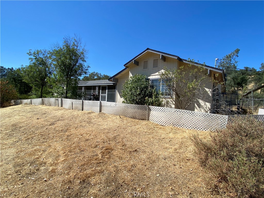 Enjoy country living year-round on this 7.58 Acre property surrounded by impressive rock outcroppings, nature and wildlife. Lots of parking, circular driveway, 2nd garage is detached with power, and there is a large flat area that would be great for RV/Boat parking, and even room for your horses or other animals! Featuring 4 bedrooms (one opposite of the others) and the Primary has a door to the backyard, 3 bathrooms, open concept from the Kitchen to the Living Room, Wood-Burning Stove, Solar (owned according to seller), a shed, animal pen, 2 car attached garage, screened in front porch, and so much more!
Yosemite Lakes Park amenities include a 9-Hole Golf Course, Pool, Spa, Clubhouse, Fairway Cafe & Yosemite Grill Restaurants, Tennis Courts, Private Lake & Pond, lots of Hiking and Horse Trails, Stables, Equestrian Center, Playground, Volunteer Fire Station, and Private Security. Don't miss this opportunity to own a home in a prime location near Rivergold School - Just a short drive to Bass Lake or Yosemite for fun, or commute to Fresno and more!