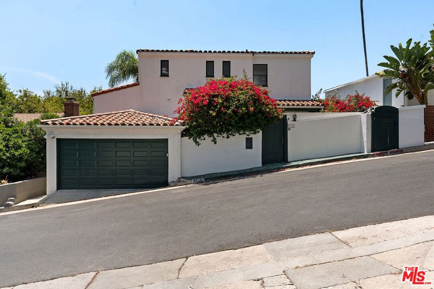 Please Note: Seller may consider carrying ... Creative Financing or Lease with Option Potential ... A true sanctuary in the city located on a cul de sac street with gorgeous views and ultimate privacy; this truly authentic Spanish residence has been thoughtfully updated while preserving its timeless character. Located just moments from the best of shopping, dining, grocery stores, and hiking trails, this home blends elegance, warmth, and functionality in one of the most sought-after neighborhoods in LA. Be enchanted by  original crown mouldings, refinished hardwood floors, and bespoke Murano light fixtures that honor the home's architectural heritage. The spacious living room is centered around a wood-burning fireplace and the home is framed by multiple Juliette balconies, inviting in light and breezes. Memories will be made in the custom kitchen, featuring stainless steel appliances, durable quartzite countertops, elegant cabinetry, a picturesque Bertazzoni range. Enjoy casual mornings in the cozy breakfast nook with custom chic upholstery, or entertain in style in the formal dining room, adorned with designer wallpaper and a custom wet bar. The primary bedroom offers a tranquil retreat with a spa-inspired bathroom featuring steam shower, and views you can enjoy morning or evening. A second bedroom and additional flex space offer versatility for office, nurseries, or home-exercise equipment. An additional ADU-style suite with its own kitchenette and bath provides perfect flexibility for guests, work-from-home needs, or extended family. Outside, the home truly shines. A wraparound terrace, side patio, and private flat grassy yard are perfect for entertaining or enjoying serene moments. Dine al fresco on the custom-built deck, relax by the Moroccan-inspired fountain, or pick fresh fruit from your own lemon and pomegranate trees. With an attached garage, ample storage, and convenient street parking, this home offers both beauty and practicality. Additional upgrades throughout with smart home features including NEST, security cameras, door locks, and a Sonos sound system, this property also includes a new roof, newer plumbing and electrical, and a large laundry room. Located just minutes from Chateau Marmont, Sunset Plaza, Pace Restaurant, and top-rated schools like Wonderland Ave Elementary, plus Bristol Farms, Whole Foods, Trader Joe's, Equinox, farmers markets, and Runyon Canyon-- this is a rare opportunity to own a one-of-a-kind residence that blends authentic charm with luxurious modern living.