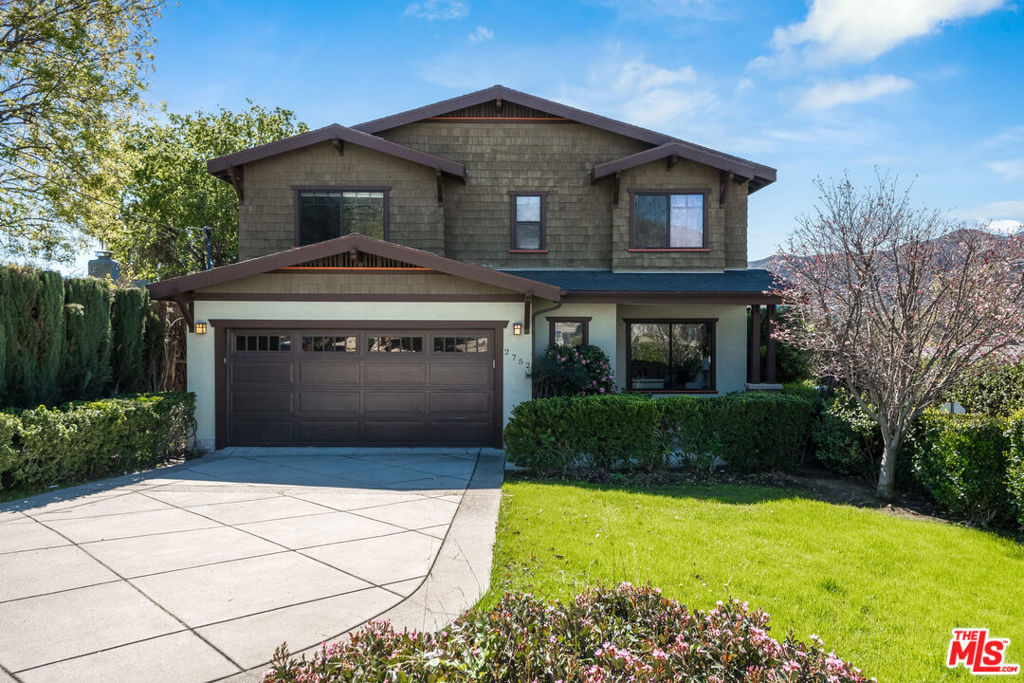 Nestled in the highly sought-after neighborhood of La Crescenta, this stunning custom-built Craftsman seamlessly blends timeless design with modern comforts. Built in 2007 with meticulous attention to detail, this two-story residence offers 2,850 square feet of thoughtfully designed living space, featuring 4 bedrooms and 3.5 bathrooms. Upon entry, gleaming hardwood floors welcome you into a light-filled living room, where natural light pours through expansive windows. The heart of the home is the open-concept kitchen, gathering room, and dining area, all overlooking the beautifully landscaped backyard. The chef's kitchen is a masterpiece, boasting honed black granite countertops, a rich stone backsplash, custom wood-grain cabinetry, stainless steel appliances, and a large center island with bar seating perfect for casual dining or entertaining. The adjacent gathering room is anchored by a traditional Craftsman-style gas-burning fireplace, creating a warm and inviting atmosphere. A formal dining room and guest powder room complete the main level. The second floor features a well-appointed primary suite, three additional spacious bedrooms, two bathrooms, and a convenient laundry room. A true sanctuary, the primary suite offers serene views of the Foothills, along with dual oversized walk-in closets. The spa-inspired primary bath boasts a soaking tub, a separate rainfall-style stall shower, and a dual vanity, creating the ultimate retreat. Step outside to a private, lushly landscaped backyard, where a wood deck invites you to relax or entertain. Overlooking the grassy lawn and mature landscaping, this outdoor space is perfect for summer BBQs, gatherings, or peaceful evenings under the stars. This meticulously maintained home includes numerous upgrades, such as: Tesla solar panels for energy efficiency, Central air & heat for year-round comfort, Attached 2-car garage with direct access , Recessed lighting throughout, Nest thermostat & Ring doorbell for modern convenience, Hardwood flooring for timeless elegance. Situated in an ideal location, this exceptional home is just moments from award-winning Blue Ribbon schools, scenic hiking trails, parks, restaurants, and shopping. A true one-of-a-kind gem, this property is the perfect place to call home.