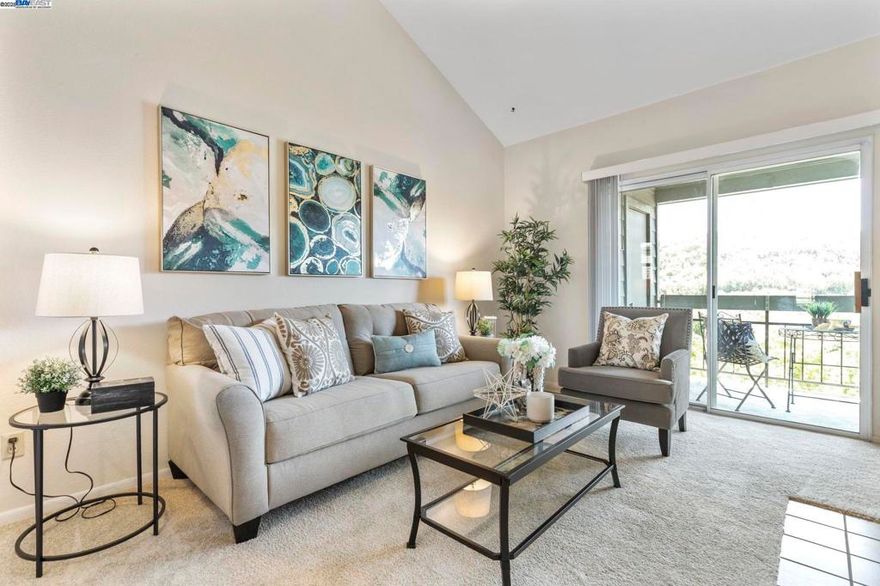 Welcome to this well-maintained 2nd-floor condo in the highly sought-after Canyon Meadows community. ONLY FIVE STEPS UP TO THE FRONT DOOR!  This home features a clean original condition with a bright, open floor plan, a cozy wood-burning fireplace, and a private balcony with AMAZING VIEWS and NO direct rear neighbors! The unit includes a detached 1-car garage and ample visitor parking for added convenience. Enjoy resort-style living with HOA amenities that include two pools, a spa, tennis courts, basketball and volleyball courts, a clubhouse with gym, car wash area, and water and heated water included in HOA dues. Located within the award-winning Pleasanton school district, and offering easy access to major commuter routes, BART stations, shops and restaurants, this condo is priced below comps—don’t miss this incredible value!