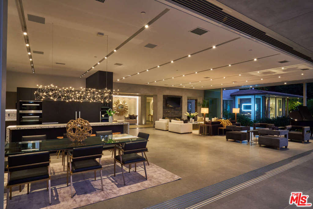 A five star Bali resort - in the heart of Trousdale Estates. One of the most organic and spectacular properties in Beverly Hills! This Zen inspired contemporary masterpiece boasts a 60' x 40' great room "wall of glass" with 100 feet of automated Fleetwood sliding glass panels - providing abundant natural light and creating indoor/outdoor living at its finest. The automatic glass panels open to a Balinese-inspired outdoor oasis with a zero-edge infinity pool that appears to float inside the home and a large Koi pond with waterfall and fire pit. A Porcelanosa and Miele designed kitchen overlooks the outdoor living area with a large fully-equipped outdoor kitchen. The master suite is adorned with a wall of stone and fireplace and includes a deck with a fire-pit overlooking the Koi pond and a serene view of the expansive backyard and incredibly stunning pool. The ultimate in Zen, serenity and elegance for the sophisticated buyer.