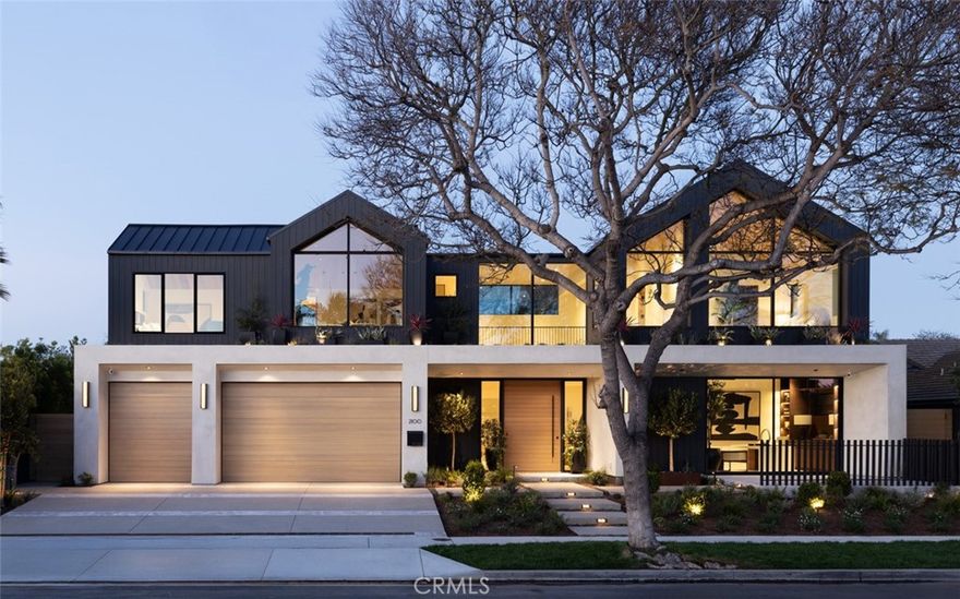 Step into an architectural masterpiece where every element of design invites you into a world of elegance and innovation. The journey begins at a double-height entry, framed by a grand custom oak archway, bringing to mind the tranquil water wall of the pool. Towering 16-foot privacy hedges guide your gaze inwards toward the expansive great room with kitchen and dining areas. Central to the home is a chef's kitchen featuring a Pitt cooktop and elite Gaggenau appliances that enhance the culinary experience, complemented by an island with fluted woodwork, masterfully placed Taj Mahal leather quartzite, and seamless custom oak cabinetry. A convenient automatic pass-through window connects to an outdoor eating area, beside a matching secondary full catering kitchen hidden behind custom-created fluted glass and steel archways. Here, in the heart of the home, additional majestic oak archways merge form and function seamlessly, centering the bar area and art walk behind.The contemporary design, envisioned by award-winning architect Eric Aust, enhances the neighborhood's charm with dramatic dormers, a lush full width living roof, expansive windows, and expert landscaping from Garden Studio. Within its striking exterior, the home features five ensuite bedrooms, five-and-a-half baths, plus an office and a separate loft, spanning 4,857 square feet of harmonious living space. The interior designed by Serendipte, blends luxury and comfort with white oak flooring, vaulted ceilings, and rich limestone and quartzite details, creating an upscale ambiance across two levels. The first-floor bedroom suite offers easy access to the office, which opens to a private front patio. Upstairs, additional bedrooms with private baths and a bonus room offer further living flexibility. The primary suite is a sanctuary with a massive walk-in closet, floating vanities, a freestanding tub, and an indulgent steam shower. Every detail speaks of handcrafted excellence, from wood-clad archways to mud in LED lighting and natural stone tiles by Ann Sacks and Walker Zanger. A three-car garage further provides function with two entry points one to the secondary kitchen and one to the mud room, with a laundry room located upstairs. Wrapped around this home is a lush backyard oasis with a custom pool, spa, 700 sqft California room, full outdoor kitchen, flush mount heat lamps, sound, fireplace and fire pit. This exclusive SkySail residence is destined to elevate your lifestyle for generations.