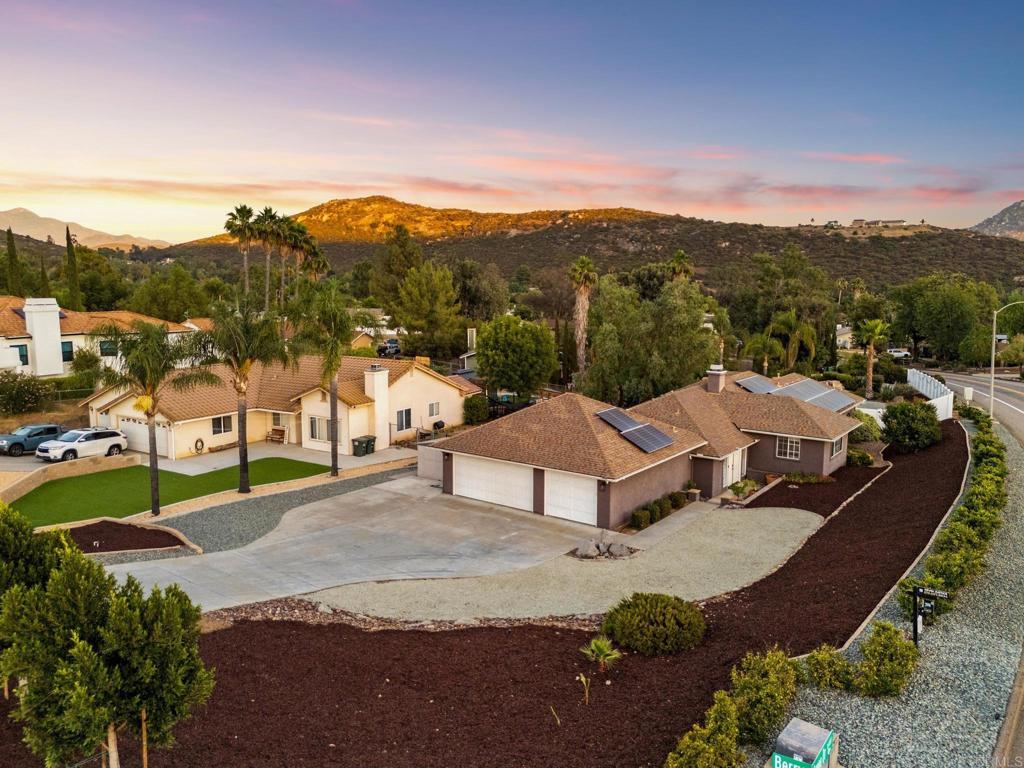 Welcome to your personal paradise in the San Diego Country Estates, 16403 Arena Dr. This spacious and beautifully updated 4-bedroom, 3.5-bathroom home offers the ultimate in resort-style living—perfect for multigenerational families or anyone seeking comfort, style, and outdoor enjoyment year-round. Step into your tropical backyard oasis featuring a custom sparkling pool with jacuzzi, waterfall, slide, and easy entry baja step, heated with solar power for year-round fun. Imagine evenings by the outdoor firepit, taking in the breathtaking mountain views. Inside, you’ll find two luxurious primary suites, perfect for privacy and flexibility, along with two additional bedrooms connected by a convenient Jack-and-Jill bathroom. The open-concept family room features a cozy fireplace and a stylish wet bar—ideal for entertaining. The large and open kitchen features stainless steel appliances and gorgeous island, creating the perfect space for your culinary + entertaining needs. Upgrades include, tile flooring, durable vinyl plank flooring in the bedrooms, owned solar panels that have historically provided energy credits, EV hookups in the 3-car garage, and RV parking for your outdoor adventures. Located in the highly desirable San Diego Country Estates, you’ll enjoy access to local parks, golf, tennis, horse back riding trails and hiking—all just minutes from your doorstep. Don’t miss your chance to own a slice of resort-style living in one of San Diego’s best-kept secrets!