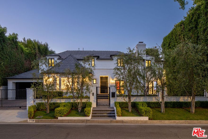 Welcome to the epitome of Beverly Hills contemporary living. Nestled on the rare cul-de-sac of 1719 Ambassador Avenue, just one minute from the iconic Beverly Hills Hotel, this residence embodies world-class design with a reverent nod to its origins. Originally built in 1935, the home has been completely reimagined and restored, thoughtfully preserving its classic facade while unveiling a modern masterpiece within. Spanning 5,268 square feet, every detail of this estate reflects meticulous craftsmanship. Expansive Fleetwood windows and doors dissolve the boundaries between indoors and out, flooding the interiors with natural light and embracing a true California lifestyle. At its heart, a state-of-the-art kitchen features a massive dolomite marble island, perfectly paired with Miele appliances, setting the stage for both everyday living and refined entertaining. White oak herringbone floors run throughout, exuding warmth and tranquility at every step. The outdoor experience is equally remarkable, centered around a 50-foot lap pool and spa designed to accommodate up to eight. This serene backyard oasis is perfect for both intimate relaxation and grand gatherings. Beyond the visible luxuries, no expense has been spared from the structural execution to the subtle design flourishes that elevate the residence into a work of art. A rare opportunity to own a piece of Beverly Hills history, completely transformed for the modern era. World-class design in a world-class location awaits.