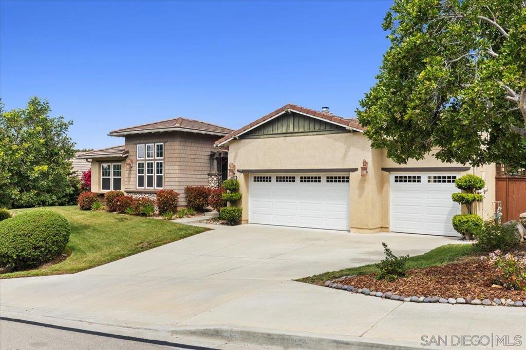 Nestled in the highly desirable Hidden Trails community of East Escondido, 3180 Ridgeline Place offers an inviting, serene atmosphere, perfect for embracing the everyday moments of life. This thoughtfully designed single-story home is ideal for both daily living and entertaining. The spacious layout includes a large primary suite with a walk-in closet and en-suite bath, as well as two additional well-sized bedrooms. A dedicated home office/guest suite with a kitchenette and its own private entrance provides a quiet space for remote work or a functional, studiostyle living area for guests or extended family. At the heart of the home is the custom-designed kitchen, which flows seamlessly into the living room and adjacent dining area—perfect for preparing meals and spending quality time with loved ones. Outside, the beautifully landscaped yard features a built-in natural gas BBQ and cooking area, a large patio for entertaining, and a fun putting green for guest enjoyment. Additional features of this inviting home include a large laundry room, whole-house fan, dual-zone air conditioning, solar panels for energy efficiency, and a three-car garage complemented by a generous driveway offering additional parking. Well-maintained and lovingly cared for, 3180 Ridgeline Place is ready for new owners to enjoy its warmth and charm. This peaceful home presents a rare opportunity to live in a truly special neighborhood.