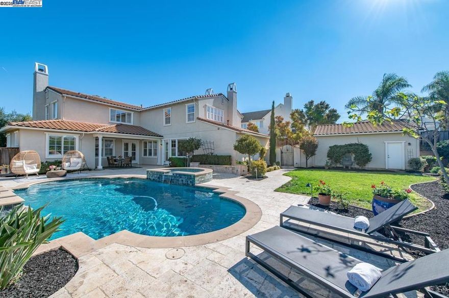 Beautiful 4 bedroom, 4.5 bath, 2 story, 3 car garage, approx. 3,770 sqft, majestically sitting on approximately an 18,000 sqft lot and on an elevated corner lot with no side neighbors, One full bedroom & bath on the first level, panoramic views of greenbelt/park, formal living room w/fireplace, formal dining room w/tile flooring and crown molding, recessed lighting, built-in speakers, crown molding and 14 x 24 inch travertine tile flooring throughout the house, beautiful gourmet eat-in kitchen with island and breakfast bar, ample cabinets for storage, granite counter tops & tile back splash, stainless steel appliances, Built-in Kitchen Aid refrigerator, 6 burner stainless steel gas cooktop, butler pantry, walking closet, crown molding, recessed lighting, family room with gas fireplace, nook for entertainment center and surround sound, large primary bedroom suite with sitting area, fireplace, walk-in closet, primary bathroom with sunken tub, tile counter tops and stall shower and plantation shutters, each bathroom has its own bathroom, upstairs laundry room, built-in bookshelves. resort like backyard, pool/spa & patio with stone decking. Close to wineries, parks, shopping, restaurants, schools, Sandia and Lawrence Livermore Labs, ACE train, Lake Del Valle & downtown Livermore!