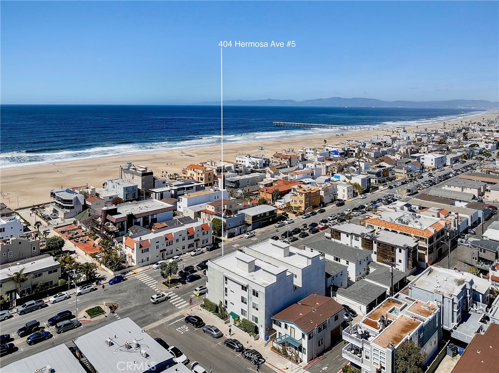 **Available August 1st - Offered 12 mo, or flexible short term. Fully furnished “Four Seasons” inspired rental, with details down to the linens and silverware, utilities included.** Welcome to 404 Hermosa Avenue #5, a breathtaking ocean view, corner penthouse condo, perfectly located steps to the beach and Downtown Hermosa Beach! This 2-bedroom, 1-bathroom retreat offers unobstructed ocean, surf & sand views, brand new modern upgrades throughout, and the ultimate in beach living.
Step into a beautifully updated home, where contemporary design meets coastal charm. The spacious living area seamlessly extends to a private balcony, providing wide open views of the Pacific Ocean—perfect for morning coffee or sunset relaxation. The kitchen and bathroom have been tastefully remodeled with the perfect blend of convenience and elegance. Amenities include new stackable washer and dryer and plenty of closet and storage space. With no neighbors above, this unit offers peace and privacy in one of California’s most coveted beachside communities.
Just steps from the sand, yet tucked away from the crowds, this condo delivers the best of coastal living. Enjoy the convenience of one car gated garage parking and three additional street parking passes, a well-maintained building, and proximity to top-rated schools, trendy restaurants, bars, and boutique shops.
Don’t miss this rare rental opportunity—live the endless summer lifestyle in Hermosa Beach!