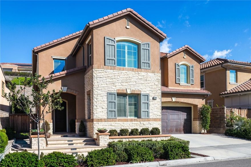 Offering Warm Modern Luxury, this Entertainer’s Paradise Embodies Model Quality Design and Contemporary Functionality. Seamlessly Blending Artisanal Style with a Modern Floor Plan this home is an Absolute Masterpiece! Located in the Gated Resort Style Community of The Oaks, the Residence Curates Stunning Designer Landscaping and Functional Indoor/Outdoor Living featuring an Upgraded Designer Tile Front Porch Entry and Custom Designed Driveway. Upon entry the Luxury Upgrades are immediately distinguished with Exquisite Porcelain Tile Flooring, Soaring 2 Story  Ceilings and an abundance of Natural Light. The Spectacular Chef’s Kitchen features High End Upgrades including Quartz Countertops, Stainless Steel Gourmet Appliances, 6 Burner Gas Stove, Dual Ovens, Upgraded Cabinets, Center Island w/ Bar Seating, Secondary Prep Kitchen and Spacious Walk-In Pantry. A Fully Retractable Spectacular Multi-Panel Stacking Glass Door allows the Kitchen to Fully Open up to the Private Backyard Oasis creating the Indoor/Outdoor Living we all love. The Backyard is private and spacious featuring a Covered California Room, Designer Hardscape, Artificial Turf and a Beautiful Expansive Water feature.  The highly desirable Downstairs Bedroom & Full Bathroom and additional Powder Room offers Incredible Flexibility for the Modern Day Buyer. Follow the Gorgeous Designer Wrought Iron Staircase upstairs into the the Spacious Multi-Purpose Loft and tech deck space, the perfect at home work station.  Continue the tour and find the Convenient Upstairs Laundry Room, 3 Bedrooms including the Spectacular Primary Suite Retreat. Relax your Mind in the Designated Restorative Enclave of your Primary Suite Retreat with Lush Backyard Views from your Spacious Private Outdoor Enclave.  The Primary Bath Stuns w/ Upgraded Cabinets and Counter Tops, Soaking Tub, Upgraded Walk-In Shower, Designer Tile and Spacious His & Hers Walk-In Closets. Additional Custom Luxury Upgrades Include Plantation Shutters, Custom Front Yard Tile Hardscape & Drought Tolerant Landscaping, Spacious 2 Car Garage and Extended Driveway. This One Is Special!