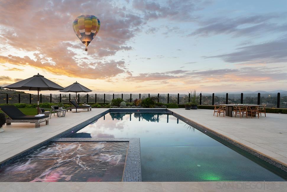 SPECTACULAR 270 DEGREE VIEWS! Come experience luxury at its most transcendent as it stands at the apex of quality and style with its romantic architectural lines and contemporary design elements. This luxurious dwelling overlooks the rolling hills and canyons of Rancho Santa Fe where you may catch a hot air balloon in the distance and the magnificent greens of nearby golf courses. The glorious view loses none of its romance even at night, when the evening lights often glimmer bewitchingly or endless starry skies mesmerize. San Diego is the perfect place to embrace outdoor living and this home doesn’t disappoint with its spacious entertaining deck featuring a sparkling pool/spa, an outdoor kitchen, and turf with seamless flow between your indoor and outdoor worlds when the La Cantina-style doors are open wide, thus maximizing square footage, optimizing entertaining capabilities and capitalizing the spectacular views. Boasting of a one-of-a-kind driveway within the community, your journey begins at the end of the cul-de-sac as you meander to this contemporary masterpiece nestled on a private, oversized .64 acre lot. Upon entry, your gaze is drawn to blue sky views through La Cantina-style doors. The open-concept of the kitchen and main-living areas, combined with La Cantina-style doors creates an expansive feel extending the comforts of the interior outdoors. Most living spaces are on one level, with an added second level retreat featuring a living room, spacious bedroom, walk-in-closet, elegant full bathroom with walk-in-shower and a spacious balcony overlooking the spectacular courtyard. An owned solar system produces more energy than the property uses monthly with 2 Tesla batteries for fast charging Tesla cars. State of the art pool with dual heaters and automatic cover. Vista Santa Fe provides a resort-level lifestyle by offering controlled access, first-class recreation facilities. This community is surrounded by highly-acclaimed schools and offers an abundance of shopping, dining, and entertainment venues to fill your time. Too much to list, please see the Features List in the document section for specific information on what this magnificent property has to offer! Opulence awaits!