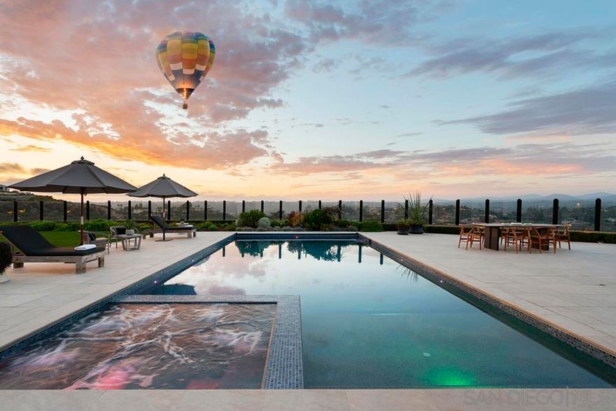 SPECTACULAR 270 DEGREE VIEWS!  Come experience luxury at its most transcendent as it stands at the apex of quality and style with its romantic architectural lines and contemporary design elements. This luxurious dwelling overlooks the rolling hills and canyons of Rancho Santa Fe where you may catch a hot air balloon in the distance  and the magnificent greens of nearby golf courses. The glorious view loses none of its romance even at night, when the evening lights often glimmer bewitchingly or endless starry skies mesmerize. San Diego is the perfect place to embrace outdoor living and this home doesn’t disappoint with its spacious entertaining deck featuring a sparkling pool/spa, an outdoor kitchen, and turf with seamless flow between your indoor and outdoor worlds when the La Cantina-style doors are open wide, thus maximizing square footage, optimizing entertaining capabilities and capitalizing the spectacular views.  Boasting of a one-of-a-kind driveway within the community, your journey begins at the end of the cul-de-sac as you meander to this contemporary masterpiece nestled on a private, oversized .64 acre lot. Upon entry, your gaze is drawn to blue sky views through La Cantina-style doors.  The open-concept of the kitchen and main-living areas, combined with La Cantina-style doors creates an expansive feel extending the comforts of the interior outdoors. Most living spaces are on one level, with an added second level retreat featuring a living room, spacious bedroom, walk-in-closet, elegant full bathroom with walk-in-shower and a spacious balcony overlooking the spectacular courtyard.  An owned solar system produces more energy than the property uses monthly with 2 Tesla batteries for fast charging Tesla cars. State of the art pool with dual heaters and automatic cover. Vista Santa Fe provides a resort-level lifestyle by offering controlled access, first-class recreation facilities. This community is surrounded by highly-acclaimed schools and offers an abundance of shopping, dining, and entertainment venues to fill your time. Too much to list, please see the Features List in the document section for specific information on what this magnificent property has to offer! Opulence awaits!