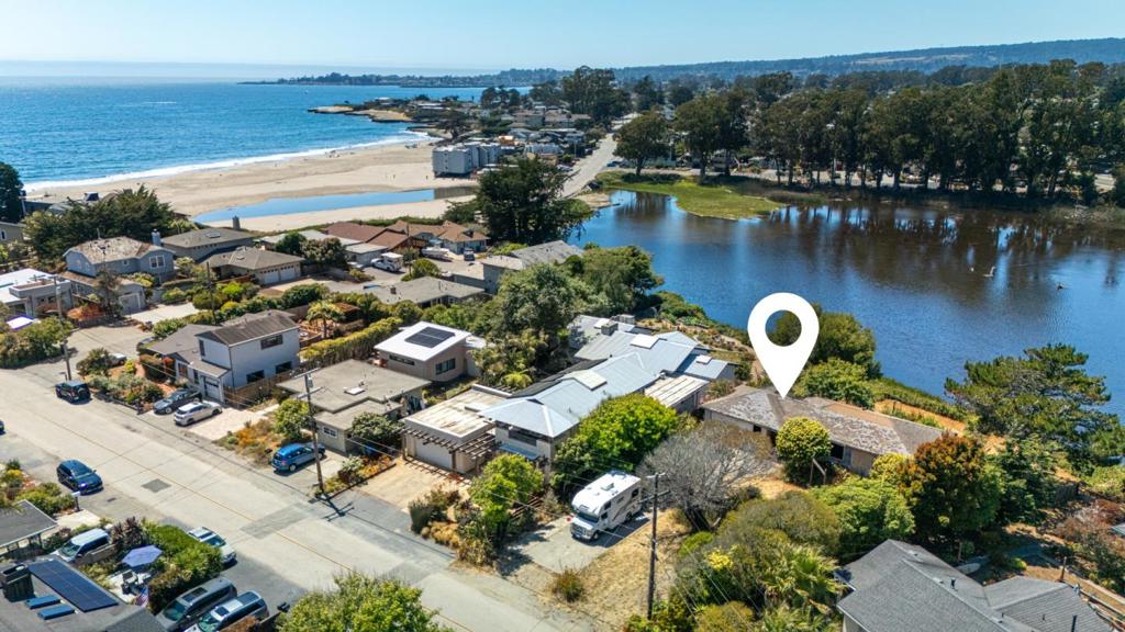 Prime opportunity to build your dream home on a rare, expansive lot of approximately 17,000 sqft, fronting a tranquil lagoon (no back fence or neighbor). Located on the ultra-quiet and sought-after 24th Avenue, less than 10 houses from the sand. The existing structure is a total teardown, presenting a blank canvas to create the estate or family compound of your dreams. Design a one-of-a-kind custom home on this unique parcel, offering space, privacy, and unbeatable location. Perfectly positioned between the Santa Cruz Yacht Harbor and Capitola, close to Pleasure Point surf breaks, 41st Avenue's shops and restaurants, and miles of scenic coastline. Rarely do parcels of this size, fronting a lagoon, come on the market. Own a legacy property on one of the best streets in Santa Cruz.