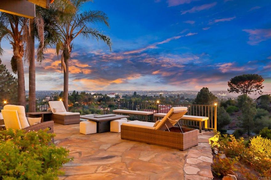 Move-in ready and highly upgraded, this ocean-view estate in one of Vista’s most coveted neighborhoods offers the perfect blend of elegance, comfort, and entertainment. Perched on over an acre, the home boasts sweeping 180-degree views of the ocean, rolling hills, city lights, and stunning sunsets—framed by expansive windows throughout. Just 15 minutes from the coast, you’ll enjoy refreshing ocean breezes and quick access to the beach. Inside, 4 bedrooms, 2 full baths, and 2 half baths are complemented by soaring open-beamed ceilings, moody designer finishes, and two wood-burning fireplaces. The gourmet kitchen is a showpiece, featuring a Viking cooktop, double convection oven, and a 9-foot custom hand-cut walnut island paired with a handcrafted dining table. Modern upgrades include owned solar, Google Smart Home with wall-mounted control panel, smart TVs, keyless entry, and an oversized 3-car finished garage for convenience and storage. Outdoors, enjoy resort-style living with custom stonework, hardscaping, and a covered Italian rock grotto—complete with ocean views and outdoor TV—perfect for year-round entertaining. A private vineyard with Cabernet & Syrah vines, plus fruit and nut trees, add to the property’s unique farm-to-table lifestyle. All tucked away in a gated, private setting—yet just minutes to downtown Vista and major freeways (78, 5, and 15). A rare, move-in ready ocean-view estate and true entertainer’s dream—this one is a must see!