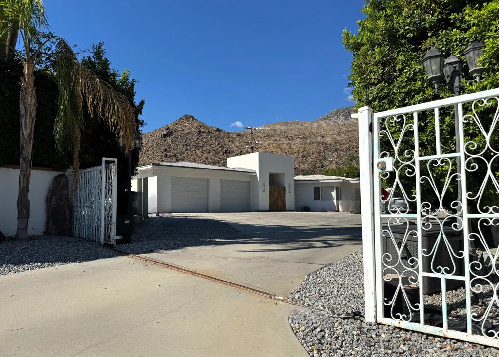Situated on a gated parcel in the coveted Mesa neighborhood, this expansive property offers nearly half an acre (.46 acres) on a cul-de-sac with breathtaking mountain views, pool, spa, and endless potential. The residence spans over 3,600 square feet and combines vintage Palm Springs character with a newer addition featuring a dramatic great room and an oversized four-car garage.The flexible layout includes multiple living areas, generous bedrooms, and an older detached garage that could be reimagined as a casita, studio, or guest retreat. With its substantial footprint and prime lot, this property provides options: move in and update gradually, or take advantage of the site's size and location to create a truly extraordinary estate.The Mesa is one of Palm Springs' most desirable enclaves, celebrated for its historic charm, unique architecture, and proximity to downtown dining, shopping, and entertainment. Few opportunities arise to acquire a property of this scale with views, and versatility.Whether restored, refreshed, or reimagined entirely, this home presents a rare chance to craft your dream desert retreat. Offered at $1.5M, it represents an incredible canvas in a setting where neighboring homes trade well above that! Don't miss the chance to make this special property your own.