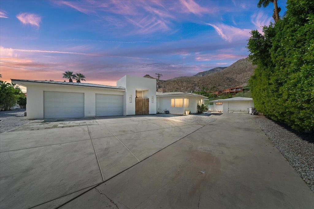 Situated on a gated parcel in the coveted Mesa neighborhood, this expansive property offers nearly half an acre (.46 acres) on a cul-de-sac with breathtaking mountain views, pool, spa, and endless potential. The residence spans over 3,600 square feet and combines vintage Palm Springs character with a newer addition featuring a dramatic great room and an oversized four-car garage.The flexible layout includes multiple living areas, generous bedrooms, and an older detached garage that could be reimagined as a casita, studio, or guest retreat. With its substantial footprint and prime lot, this property provides options: move in and update gradually, or take advantage of the site's size and location to create a truly extraordinary estate.The Mesa is one of Palm Springs' most desirable enclaves, celebrated for its historic charm, unique architecture, and proximity to downtown dining, shopping, and entertainment. Few opportunities arise to acquire a property of this scale with views, and versatility.Whether restored, refreshed, or reimagined entirely, this home presents a rare chance to craft your dream desert retreat. Offered at $1.5M, it represents an incredible canvas in a setting where neighboring homes trade well above that! Don't miss the chance to make this special property your own.