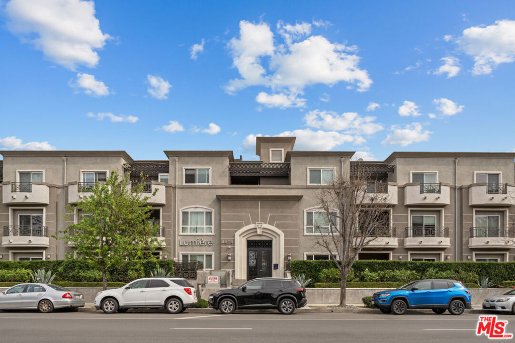 This stunning corner penthouse offers an exceptional blend of elegance, comfort, and convenience in one of Studio City's most desirable locations. Nestled on the top floor, this beautifully designed home welcomes you with a formal entryway leading into an expansive open living area, complete with recessed lighting, a cozy corner fireplace, and custom built-ins. The spacious dining area extends onto a private balcony, perfect for enjoying city views. Designed for both function and style, the gourmet kitchen features sleek stainless steel appliances, pristine stone countertops, and a breakfast bar ideal for casual dining or entertaining. A rare third bathroom adds an extra layer of luxury to this unique floor plan. The primary suite is a true retreat, boasting a massive walk-in closet, serene treetop views, and its own private balcony. The spa-inspired en-suite bathroom includes dual vanities, an oversized soaking tub, and a glass-enclosed shower. The spacious second bedroom offers tons of natural light and generous closet space making it an ideal guest suite or home office. Additional highlights include in-unit laundry, hardwood floors throughout the main living spaces, plush carpeting in the bedrooms, and recessed lighting in every room. This residence also includes two individual parking spaces and access to many guest parking spots. Lumiere is an impeccably maintained, boutique-style building featuring a beautifully landscaped central courtyard with a fountain and outdoor fireplace. Residents also enjoy a fully equipped gym on the first floor. Situated in a highly walkable neighborhood, this home is just two blocks from Beeman Park and within close proximity to top-tier restaurants, shops, and entertainment. This is a rare opportunity to experience luxury living in one of Studio City's most sought-after buildings.