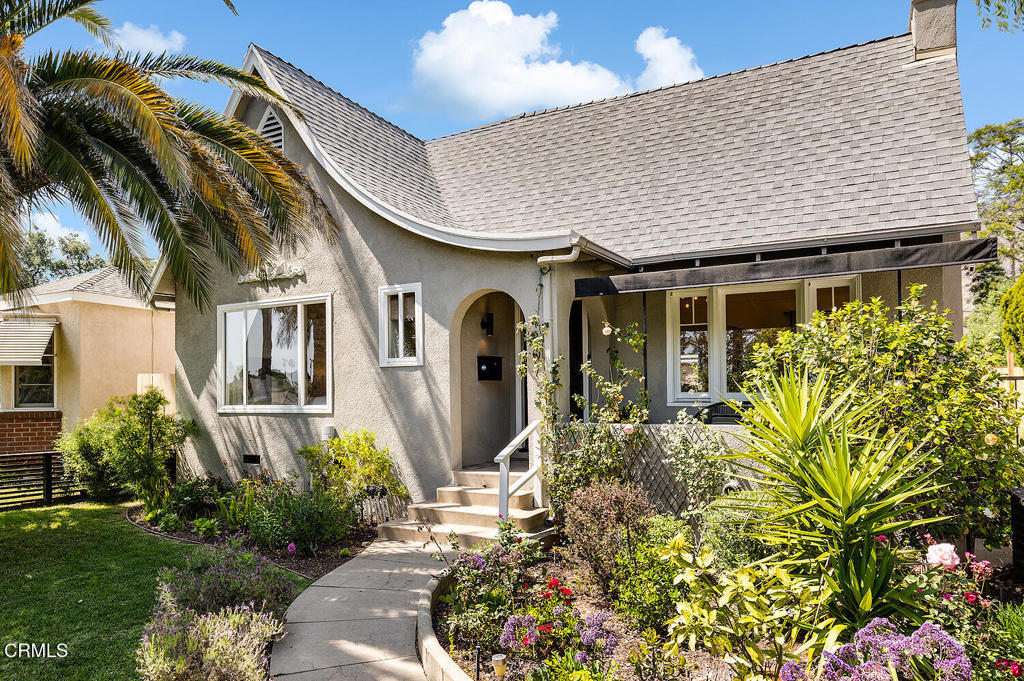 Updated and perfected, this English cottage with finished studio and separate ADU offers location, architecture and optional income. With a captivating front garden and classic 1927 'catslide' roof and facade, this home charms from the street. Fruiting pomegranate trees, and date palm create attractive privacy while fragrant lavender and jasmine perfume the air around this renovated 3 bedroom, 2 bath home. The covered front porch with arched entry is framed by climbing roses and casement windows, lending an air of storybook fantasy. Inside, contemporary wide plank floors juxtapose with original features like plaster walls and coved tray ceilings. Views through the living room with beautiful wavy glass are leafy green and lovely. The dining room is light and bright with access to the adjacent east-facing veranda, extending entertaining space outside. The renovated kitchen with recently replaced cabinetry enjoys garden views and updated attached laundry room. Two spacious, light-filled bedrooms, and stylish bath with dual sink vanity and updated brass fixtures. Upstairs, the primary suite with generous walk-in closet, full bath, bonus finished quiet room with flexible space and additional storage. Backyard offers a private landscaped brick patio, two grassy play areas and spa. The recently finished, conditioned studio garage with wide plank flooring, storage and two sets of french doors to the garden offers a bonus family room, studio or spacious home office. Finally, the midcentury permitted ADU with kitchen, full bath and covered patio with laundry is a real asset for rental income, guests or additional living space. Less than a block from thriving local favorites Prime Pizza, Bevel Coffee, Armen Market and Altadena Beverage Company, this is a wonderful opportunity to own an updated historic property in Beautiful Altadena.