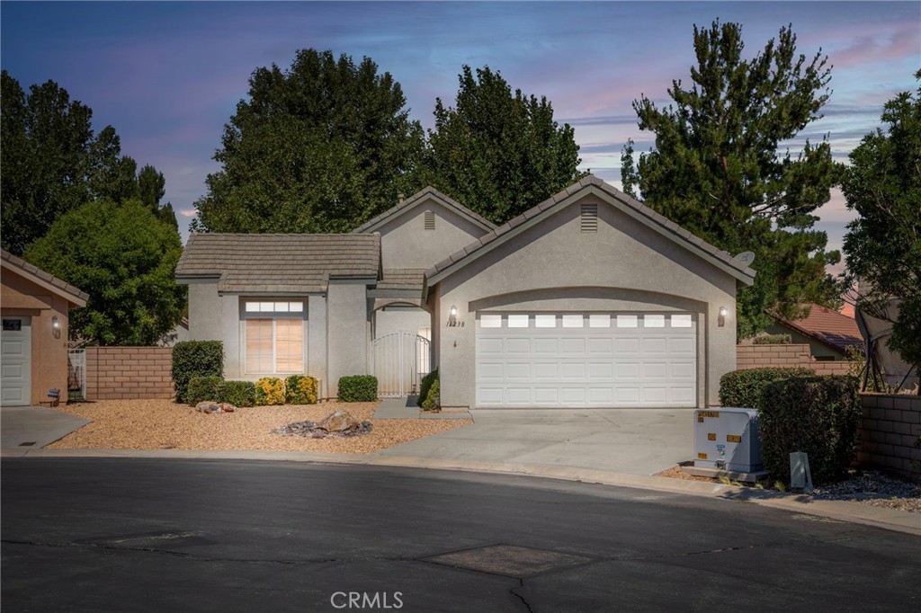 Cul-de-Sac Gem in Wyndham Rose 55+ Gated Community – This inviting 3 bed, 2 bath, 1,814 sq ft single-story offers comfort, charm, and easy living. A spacious living room with a cozy fireplace sets the stage for relaxing evenings, while the kitchen—with breakfast nook, formal dining, and all appliances included—makes cooking and hosting a joy. The primary suite is a true retreat with dual sinks, a walk-in shower, soaking tub, and walk-in closet. Two generous guest rooms provide flexibility for visitors or hobbies. Outside, unwind in your private backyard with lush grass, vibrant roses, and two covered patios—all in a peaceful cul-de-sac setting within a welcoming 55+ gated community.