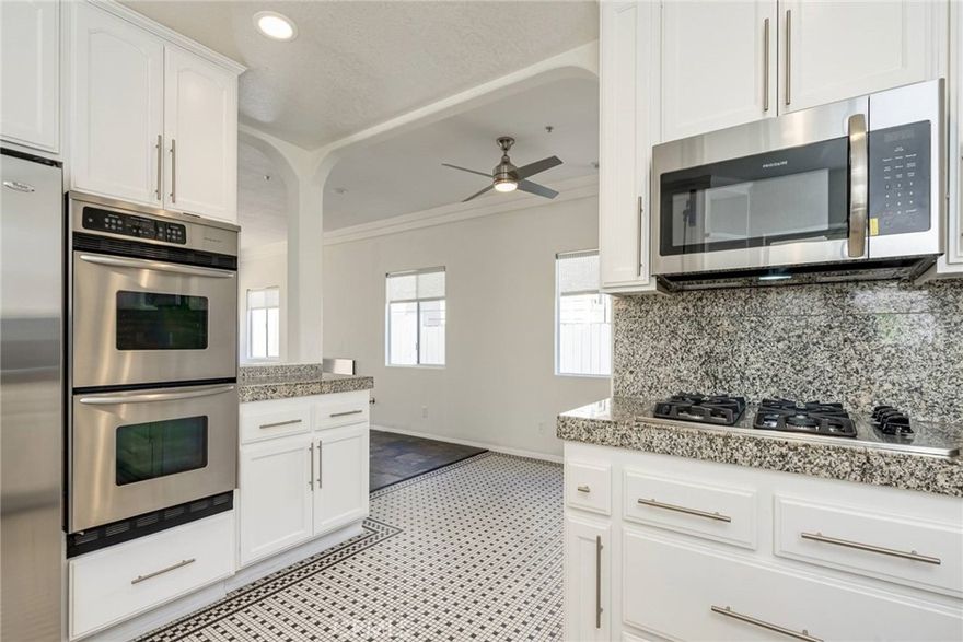 Beautifully maintained private rear unit, one of only two on the lot, located in a highly desirable North Redondo Beach neighborhood! This bright and spacious home offers a welcoming open floor plan with a large living room and adjoining dining area, plus a generous family room perfect for relaxing or entertaining.  The main living level features slate flooring, vaulted ceilings, and an abundance of natural light with views of the rear yard and patio. The kitchen is tastefully updated with granite countertops, white cabinetry, tiled flooring, and stainless-steel appliances — including a refrigerator.  
The inviting family room includes a stainless-accented fireplace, custom built-in cabinetry with a wine rack, and sliding glass doors leading to the private patio and yard — ideal for outdoor dining or lounging. There’s also direct access to the attached double garage, complete with built-in storage.  
Upstairs, you’ll find three bedrooms — including the spacious primary suite — plus a separate office with beautiful custom wood built-ins, making it the perfect “work-from-home” space. The guest bath features travertine tile floors, a large vanity, and a beautifully tiled tub/shower.  The primary suite offers vaulted ceilings, a cedar-lined walk-in closet, and a luxurious en suite bath with dual sinks, a spa tub, and a separate shower.  Additional highlights include recessed lighting throughout, neutral interior paint, and plush carpeting on the stairs and upper level. This sparkling home combines comfort, functionality, and style — all in a prime Redondo Beach location close to parks, schools, shopping, and the beach!