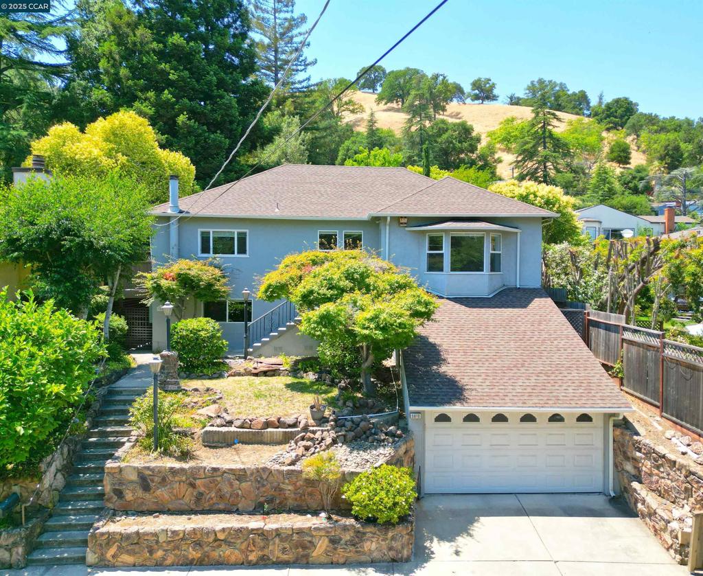 Vintage charmer tucked away in the hills of Martinez...4 Bedrooms...3 Full Baths...Large Living Room with a classic Bay Window, canned lighting and custom window moulding Too...Family size Dining room with a pass thru to the large classic kitchen with styled and railed wood cabinetry, Gas Range, Eating Area, slider to a privacy deck and even has a built-in ironing board...the upstairs has a primary bedroom with a slider door access to the backyard...Full bathroom with a shower over tub...Another full bath down the hall and a bedroom with Porthole Window and access to the backyard...Downstairs is a family dream area...Huge Family room with free standing Gas lit Fireplace, tiny kitchenette, large Dormer Bedroom, another bedroom , a full bath and a laundry room too...Has a private entry door as well...Dual Pane Thru-out...Fresh Paint Thru-out...The Backyard has a large elevated, flat, rocked Walled grass area perfect for family Fun...A wood Deck with a patio overhang runs the length of the back of the house for your enjoyment...The attached Garage has a fold-up ladder revealing a huge storage area above it...Very close to Alhambra High School and in the Highly rated JOHN SWETT ELEMENTARY school district...a few blocks to the Historic Downtown, Marina, Waterfront and Highway 4...
