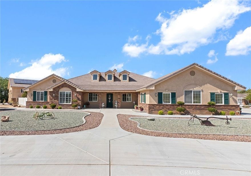 More Than a Home – A High Desert Legacy Estate Built to Last. Designed and built by a Firefighter, this estate blends strength, quality, and modern living on a full corner acre lot in one of Apple Valley’s most desirable areas. 4,596 Sq. Ft. of 2x6 construction that features a 2-story ADU/Luxury Studio Apartment, Double RV Garage & Putting Green. Together, the main home (3,512 sq. ft.) and two-story studio apartment (1,084 sq. ft.) offer ±4,600 sq. ft. of livable space designed for versatility—perfect for extended family, guests, or rental income. The main residence features 4 bedrooms (Each with their own bathroom) and 6 total baths, including two master suites, a dedicated office and large indoor laundry room. The living room showcases open step up ceilings, custom brickwork, and a wood-burning stove. The kitchen includes a large island, walnut cabinetry, under-cabinet lighting, and adjoining dining and living spaces, plus a formal dining room with custom cabinetry and lighting. The 4-car garage even has its own bathroom and washer/dryer area. The detached Double RV garage (20-ft ceilings) connects to the luxury apartment, complete with full kitchen, fireplace, efficient mini-splits, and a private deck with sunrise and mountain views. Outdoors, enjoy a 85-ft fully covered stuccoed patio, perfect for gatherings, a fire pit lounge area, and ±4,000 sq. ft. premium turf with custom made putting green. Extensive concrete work throughout the entire property, automatic drip landscaping, and paid-off solar add convenience and efficiency. Located just a couple blocks from Apple Valley Golf Course with best value memberships in California and the Hill Top Mountain Legacy Trail, for hiking, biking and unmatched views of the valley. This property offers unmatched lifestyle and durability—a true one of a kind High Desert estate. Only 2 owners.