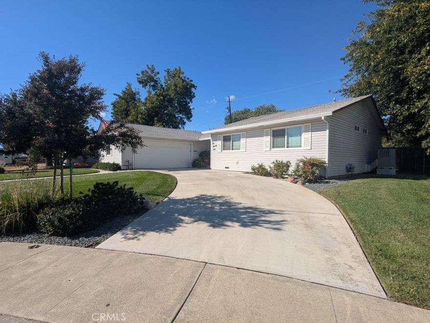 This well maintained three-bedroom, two-bath home has been loved by the same family for over fifty years.  The property features recent upgrades including a new HVAC system installed in 2013, a new roof in 2004, and durable vinyl siding added in 2001. Outdoors, the beautifully landscaped yard is equipped with a sprinkler system, installed approximately three years ago, covering both front and back yards and operating on timers for easy maintenance. Parking is convenient with a concrete driveway and an additional graveled area at the front, suitable for recreational vehicles or extra space, while the garage provides workbenches and cupboards for ample storage and workspace.