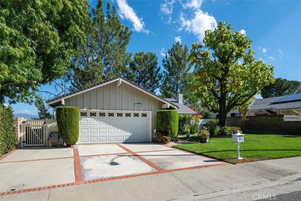 Welcome to this beautifully maintained 4-bedroom, 2-bathroom single-family home that radiates high curb appeal and charm from the moment you arrive. A lush front yard with vibrant landscaping, manicured shrubs, and colorful blooms leads you to an inviting entryway. Upon entering, you will find a well-lit interior with abundant natural light, an inviting open floor plan, and tasteful upgrades that enhance both style and comfort. The spacious living room, to your right, features a brick fireplace and large windows, flows into the dining area and kitchen. The kitchen has granite countertops, a stainless steel double oven and a new S/S dishwasher. Off of the kitchen is the laundry closet. Adjacent to the dining area is the newer glass sliding door that opens to the large backyard with a patio cover. The backyard, with mountain views, is a private oasis, filled with mature greenery and a succulent garden. At the far right corner of the yard lies a serene koi pond with a cascading waterfall. At the far left of the yard, there is a wooden deck with a jacuzzi. This outdoor space is perfect for relaxing and entertaining. Back inside, this lovely home features a master bedroom with an en-suite bathroom, 3 additional bedrooms, and a hallway bathroom. The first bedroom, located on the left side, was turned into a recreational room with the door taken out. The other 2 bedrooms and the master have mirror closet doors. Both the master bath and hallway bath have upgraded vanities and fixtures, and the hallway bath also has newer glass enclosure for the tub. Ceiling fan in the master bedroom, wood-like flooring in all bedrooms and hallway, marble flooring in the kitchen and bathrooms, freshly painted interior, crown molding, wood-like blinds, new rain gutters, sprinklers in the front and backyard, 2-car garage. No Mello-Roos, No HOA. All the thoughtful upgrades and care with timeless comfort shows pride of ownership. This home is move-in ready, and designed to impress from the first glance to the last.