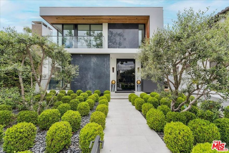 Fully Furnished! Discover this stunning modern estate in Beverly Hills, a privately gated architectural marvel that pairs striking contemporary design with turnkey convenience in one of the world's most glamorous cities. Immaculately designed and fully furnished by the renowned SIA Architects firm, every detail has been thoughtfully considered to create a seamless blend of beauty and comfort. Behind secure gates, soaring ceilings and expansive Fleetwood sliding doors flood the interiors with natural light, while exquisite custom floors add warmth and refinement. The open floor plan includes a formal dining room and two distinct living areas that extend effortlessly to the pool, barbecue, and outdoor loungeperfect for entertaining or unwinding in style. The gourmet kitchen boasts brand-new Miele appliances, sleek cabinetry, and generous prep space for both casual meals and lavish dinner parties. First-class amenities include a complete camera surveillance network, integrated home alarm system, automated privacy blinds, fireplaces, and comprehensive audio/visual wiring. Dual laundry stationsone upstairs and one in the basementadd convenience for busy households or extended stays. Upstairs, three bedrooms await, including a luxurious master suite with a spacious walk-in closet, spa-like bath, and private patio. A comfortable upstairs lounge offers flexible space for work or relaxation. The expansive basement spans over 2,000 square feet, featuring a full bar, live pond, movie room, game area, decorative wine display, and a private guest suite. Outdoors, the pool and barbecue lounge invite year-round enjoyment under the California sun, while thoughtful landscaping ensures privacy. Just a short stroll from world-class shopping and dining on Rodeo Drive, this extraordinary residence offers the rare combination of seclusion, sophistication, and proximity. Fully furnished and ready for immediate move-in, this is Beverly Hills living at its finest.