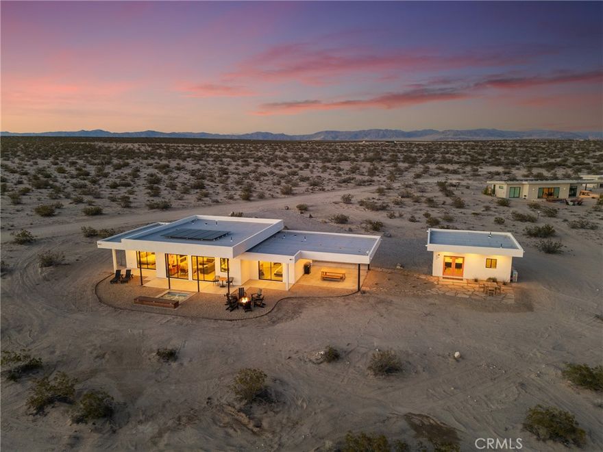 Looking for the perfect Desert Escape? It’s Orion’s Whisper --- A 5-star turn-key Airbnb retreat that’s as beautiful as it is profitable. This stunning, modern desert masterpiece spans approximately 1,326 sq ft., with an additional 375 square feet of detached ADU space, all set on 2.5 acres of serene privacy surrounded by sweeping desert views. Perfectly blending luxury living with investment potential, Orion’s Whisper is already a successful operating short-term rental with a Superhost track record and a complete STR package in place --- ready for seamless ownership and immediate income! Please note that this property features two spacious primary suites, each with a spa-style bathroom that includes glass-wall showers, modern tiles, brand-new vanities, and modern fixtures. Concrete floors are featured throughout, along with soaring ceilings and a linear zero-clearance fireplace framed by built-in contemporary shelving. The kitchen features new appliances, counters, cupboards, fixtures, and kitchenware, and comes stocked with all the desired kitchen gadgets. The wholly owned solar panels, accompanied by a brand-new solar panel gateway and mini-split A/C systems throughout the property, enhance energy efficiency in every living space. Designed for the indoor-outdoor lifestyle that defines desert living, this home brings the outside in through large, picturesque windows and clean architectural lines. The Detached ADU/guest house features a complete and stocked kitchen, en-suite bathroom, a mini-split AC/heat system, and custom double-glass entry doors. Leading you outdoors, the cocktail Pool that doubles as a hot tub is perfect for stargazing nights or sunny desert days. In addition to the guaranteed views of expansive desert scape, the wrap-around concrete patio tastefully displays Mt. San Gorgonio and Mt. Nebo! Whether you’re looking for a profitable investment, a private weekend escape, or both, Orion’s Whisper delivers on every front. Located steps from 30 acres of open government land — ideal for hiking and exploring outside of the designated Joshua Tree National Park. This property embodies tranquility, creativity, and connection to nature. Turnkey. Stylish. Profitable. It’s worth seeing for yourself. Experience the serenity, the design, and the income potential that make Orion’s Whisper one of the desert’s most sought-after retreats.