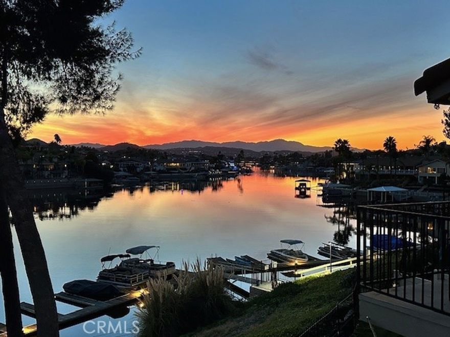 Stunning East Bay Waterfront Condo with New Boat Docks & Exceptional views!! Welcome to this beautifully remodeled end-unit, 3 bedroom lakefront condo in the prestigious Gated Community of Canyon Lake. Best Location in the complex. Perfectly positioned on the East Bay overlooking the brand New boat docks. With no neighbors above or on the side, this private retreat offers some of the best sunset views in the community, enjoyed right from your balcony off the living room.  Updated Interior with Open-Concept living. The kitchen flows seamlessly into the dining and living areas. Thoughtfully updated with designer touches through out. This home features Tuxedo-style cabinetry with butcher block countertops, tile backsplash, and a farmhouse sink with a black matte faucet. Recessed and pendant lighting, luxury vinyl plank flooring, and NEW WINDOWS. Classic ship lap paneling that enhances the coastal-chic feel. This unit's contemporary design feels fresh, stylish and move-in ready.  The spacious primary bedroom includes a custom barn-wood sliding door and a designer vanity. Other features are a contemporary chandelier in the dining room, recessed lighting,  ceiling fans, WiFi-thermostat, upgraded blinds thru-out. There is one designated carport with overhead storage, ample guest parking, and community pool and spa steps from your front door. Available boat or golf cart storage area.  Just a short stroll to the new pickle ball courts, dog park, and basketball courts. Amenities include a ski lake, golf, wake boarding, paddle boarding & more!