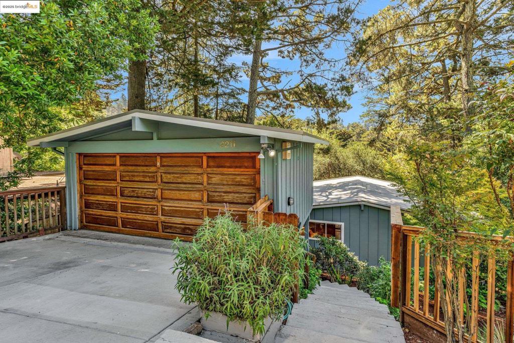 Perched in the tranquil embrace of the Oakland Hills, this mid-century treasure offers a graceful blend of architectural elegance and natural beauty. An open floor plan with vaulted ceilings and dramatic floor-to-ceiling windows frames verdant woodland and serene canyon vistas, creating a seamless connection between indoors and out. Freshly painted inside and out, the home feels renewed and inviting. The main level flows effortlessly, with sunlit living and dining spaces ideal for both intimate gatherings and lively entertaining. Two generously sized bedrooms share this level, offering comfort and versatility. On the lower level, the private primary suite is a peaceful retreat, featuring a recently renovated bath and its own deck for quiet mornings or starlit evenings. Dual decks on both levels extend the living space, each offering a serene perch to savor the surrounding greenery. A refreshed front yard adds a charming welcome, while a new roof, heat pump, and spacious two-car garage provide everyday ease, cooling, and peace of mind. Here, timeless mid-century design meets the poetry of the Oakland Hills—a sanctuary where walls of glass embrace the landscape, and every day feels touched by nature’s calm. Minutes to Montclair Village shops & restaurants, and easy freeway access.