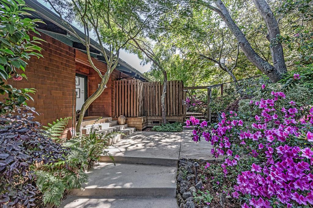 Located in the sought-after Westridge area of Portola Valley, this well-appointed home is embraced by forested surroundings & a pool on an expansive 2.37-acre lot. Classic Craftsman exterior clad in shingles gives way to bright, contemporary interiors filled with incredible natural light. Vaulted ceilings rise above the rooms, complemented by numerous skylights & an extraordinary use of picture windows & sliding glass doors that frame the breathtaking scenery at every turn. Thoughtfully designed layout spans two levels with 3 bedrooms & 2.5 baths, a recreation room with an office center & built-in Murphy bed, plus a flexible-use room for office, fitness, or play. Designed for both everyday living & effortless entertaining, the home features grand gathering spaces that flow seamlessly to expansive outdoor venues, including two separate decks, one with built-in barbecue & adjoining covered dining lounge. Adding a rare & unexpected highlight, a separately fenced & sunswept pool is positioned at one end of the grounds surrounded by lawn & wooded views. Completing the appeal are a detached two-car garage, abundant off-street parking, & access to excellent Portola Valley schools. A truly special opportunity in one of the Peninsula's most desirable neighborhoods.