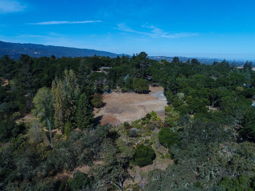 Supremely private, yet effortlessly close to everything, this expansive 3.2+ acre property sits on highly sought after Westridge, in PV's premier neighborhood. Perfectly positioned, this sun swept lot with generous unobstructed views, gorgeous scenery and mature trees, is ready for its dream home to be built. Over 2 years of extensive plan & design. The stunning plans were created by renowned Arcanum Architecture. The epitome of sleek, the gorgeous plans call for approximately 7,200 square feet of living space, highlighted by an open flowing floor plan, and include 5 bedrooms, 5.5 bathrooms, a detached garage and private Gymnasium. Impressive yet comfortable, the plans also include a designer kitchen with massive island, floor to ceiling glass windows and high attention to outdoor living as well, with a custom outdoor kitchen, stunning water features in both the front and back yard, fire pit, pool & more. Top Portola Valley schools. Plans do not have final approval