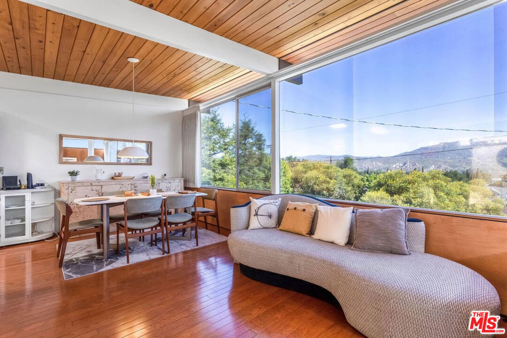 Motivated Seller! Mid-Century Modern magic with stunning mountain VIEWS! If you've been waiting for a truly special Mid-Century Modern home, this is it. Set on an oversized 20,000+ sq ft lot with sweeping mountain views, this architectural gem was designed with the same school of thought as Joseph Eichler. It's been lovingly restored to honor its original design while adding the comfort and ease today's lifestyle demands. Step inside to walls of glass, stunning rich wood finishes, and a bright, open layout that lets those incredible views steal the show. The living and dining areas flow together effortlessly, creating a perfect space for gatherings or quiet evenings at home. The bedrooms are peaceful and airy with newly refinished wood flooring that complements the home's warm, natural vibe. The fourth bedroom offers flexible space that's ideal as a home office, studio, or for making it the primary. Outside, there's plenty of room to entertain, unwind, or take in the sunset from your private patio. Whether you're hosting friends for a summer dinner party or enjoying a solo morning coffee with mountain views, this outdoor space is pure California living. Located on a quiet street just minutes from hiking trails, local shops, and freeway access to Burbank, Pasadena, Glendale and Downtown LA, this home offers the perfect balance of serenity and convenience.