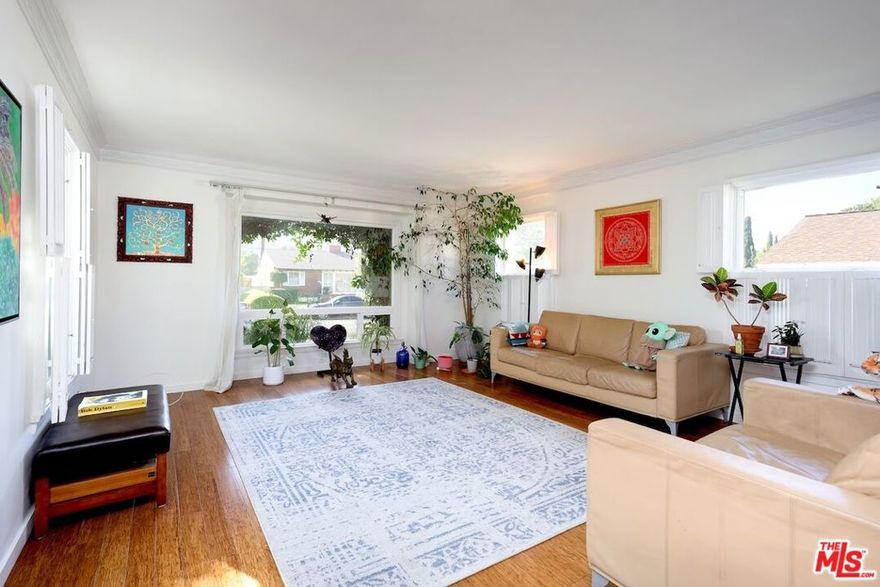 Welcome to this serene 3-bedroom + 2-bathroom single-family home in the peaceful Baldwin Hills area, showcasing classic mid-century architectural styling with clean lines and timeless appeal. Featuring a spacious garage easily convertible to an office, bonus room, creative studio, or meditation/prayer space, the home is nestled in a low-traffic pocket with sweeping views of lush hillsides and a large green backyard adorned with mature fruit trees including orange and avocado perfect for relaxation, gardening, or outdoor gatherings. Inside, beautiful bamboo flooring flows throughout, complemented by newer windows that maximize abundant natural light, flooding the open living spaces with warmth and an uplifting atmosphere. Surrounded by tree-lined streets, greenbelts, and nearby Kenneth Hahn Park, this centrally located property enjoys close proximity to LAX, the 405 freeway, beaches, Culver City, Expo lines, Whole Foods, and everyday amenities in one of LA's most coveted, community-focused neighborhoods.