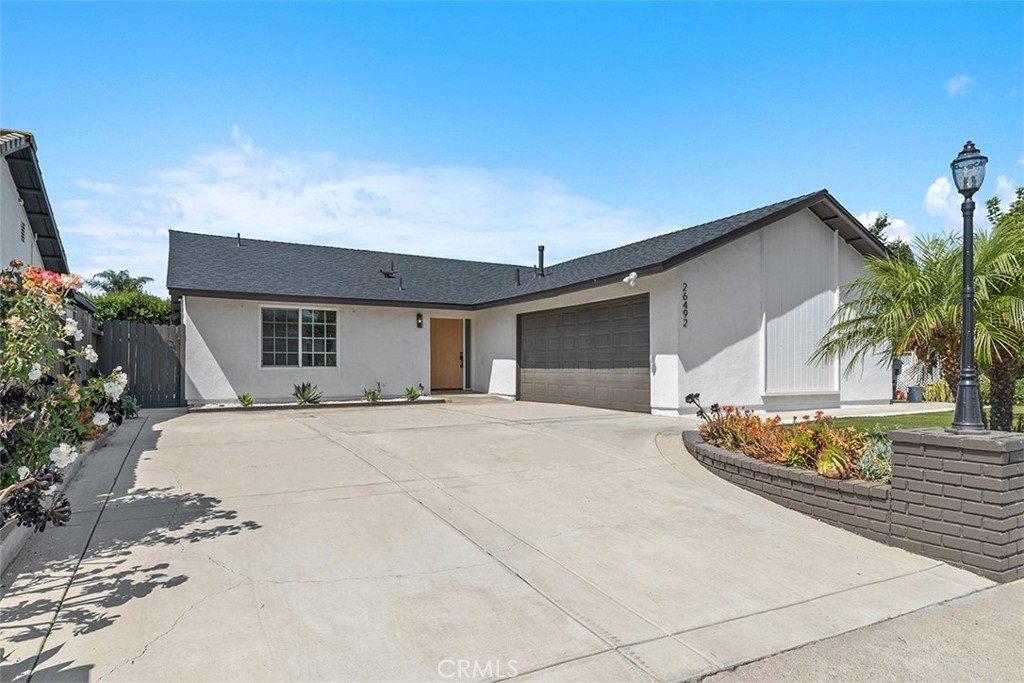 Welcome to this beautifully renovated single-story home located in the heart of South Mission Viejo. Every detail of this home has been thoughtfully updated to offer the perfect blend of modern comfort and timeless design. Enjoy peace of mind with a recently replaced roof, water heater, and an added A/C system complete with newly replaced ducting. Inside, you’ll find custom cabinetry throughout, elegant porcelain countertops, and brand-new stainless steel appliances, including a built-in microwave, all set against a sleek, contemporary kitchen backdrop. The bright, open layout is enhanced by new waterproof vinyl flooring, recessed lighting, and a striking marble stone surround fireplace that adds a sophisticated focal point to the living area. All 3 bathrooms feature tastefully remodeled showers giving you that updated zen like feel. The home’s entry is highlighted by a stunning oversized white oak front door. Step outside to enjoy lush green grass and a private backyard retreat perfect for outdoor entertaining, relaxing with family, or soaking up the California sunshine. Fresh interior and exterior paint gives the property a crisp, refreshed feel, while the epoxy-coated garage floor adds a clean, finished touch. This turn-key home offers elevated living just minutes from parks, shopping, and top-rated schools. The home is also very close to great restaraunts and the Shops at Mission Viejo and you're only 8 miles to Doheny State Beach and Dana Point Harbor. This is a truly rare opportunity.